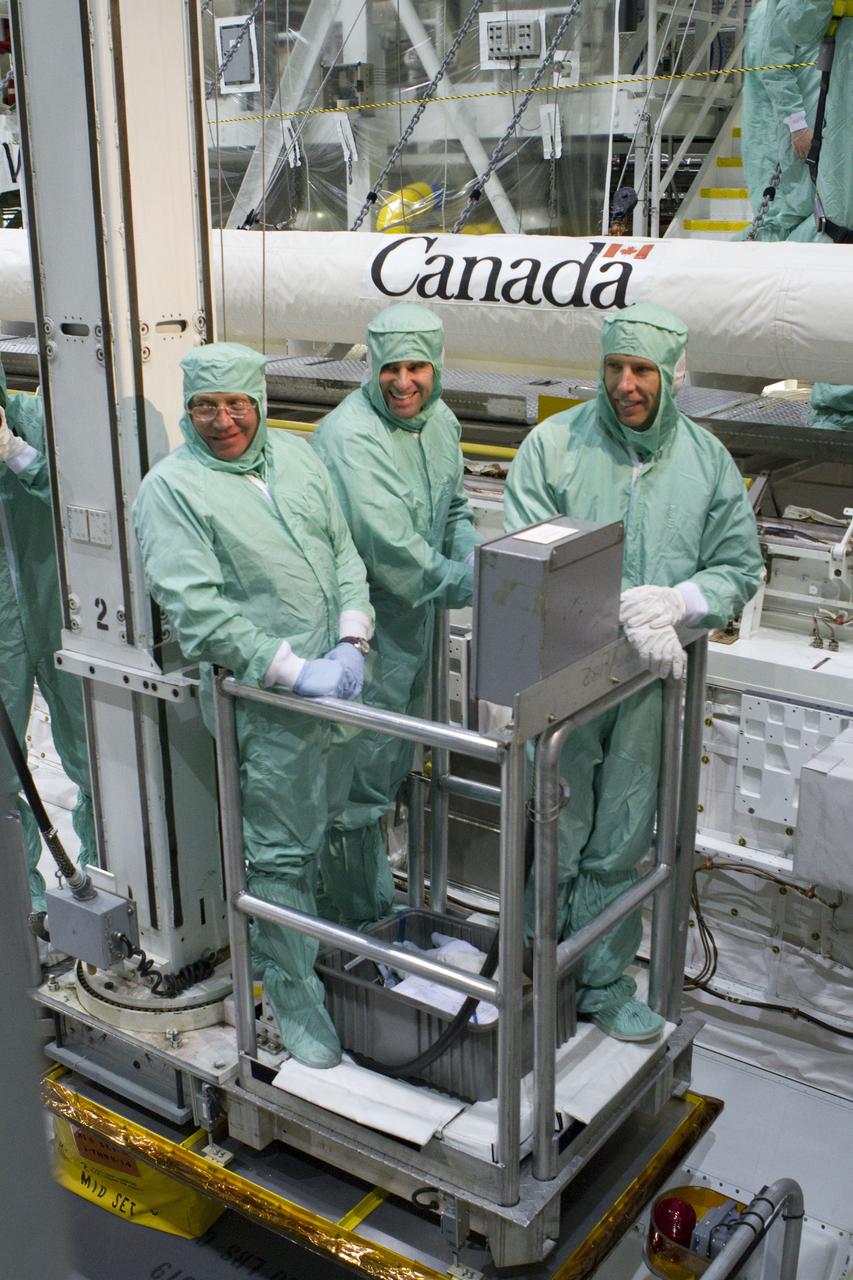 CAPE CANAVERAL, Fla. -- In Orbiter Processing Facility-2 at NASA's Kennedy Space Center in Florida, the STS-134 crew and technicians check space shuttle Endeavour's payload bay for sharp edges that could affect the astronauts' work in space. Seen here, from left, are a technician and Mission Specialists Greg Chamitoff and Andrew Feustel. The six STS-134 astronauts are participating in the Crew Equipment Interface Test (CEIT), which gives them an opportunity for hands-on training with the tools and equipment they'll use in space and familiarization of the payload they'll be delivering to the International Space Station.     Endeavour is targeted to launch on the STS-134 mission Feb. 27, 2011. For more information, visit www.nasa.gov/mission_pages/shuttle/shuttlemissions/sts134/index.html. Photo credit: NASA/Cory Huston and Glenn Benson