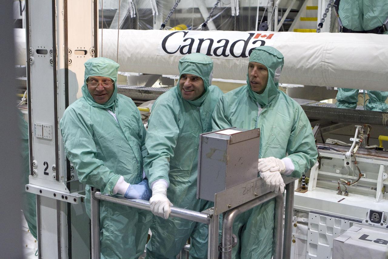 CAPE CANAVERAL, Fla. -- In Orbiter Processing Facility-2 at NASA's Kennedy Space Center in Florida, the STS-134 crew and technicians check space shuttle Endeavour's payload bay for sharp edges that could affect the astronauts' work in space. Seen here, from left, are a technician and Mission Specialists Greg Chamitoff and Andrew Feustel. The six STS-134 astronauts are participating in the Crew Equipment Interface Test (CEIT), which gives them an opportunity for hands-on training with the tools and equipment they'll use in space and familiarization of the payload they'll be delivering to the International Space Station.         Endeavour is targeted to launch on the STS-134 mission Feb. 27, 2011. For more information, visit www.nasa.gov/mission_pages/shuttle/shuttlemissions/sts134/index.html. Photo credit: NASA/Cory Huston and Glenn Benson