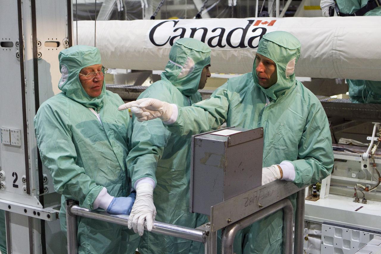 CAPE CANAVERAL, Fla. -- In Orbiter Processing Facility-2 at NASA's Kennedy Space Center in Florida, the STS-134 crew and technicians check space shuttle Endeavour's payload bay for sharp edges that could affect the astronauts' work in space. Seen here, from left, are a technician and Mission Specialists Greg Chamitoff and Andrew Feustel. The six STS-134 astronauts are participating in the Crew Equipment Interface Test (CEIT), which gives them an opportunity for hands-on training with the tools and equipment they'll use in space and familiarization of the payload they'll be delivering to the International Space Station.       Endeavour is targeted to launch on the STS-134 mission Feb. 27, 2011. For more information, visit www.nasa.gov/mission_pages/shuttle/shuttlemissions/sts134/index.html. Photo credit: NASA/Cory Huston and Glenn Benson