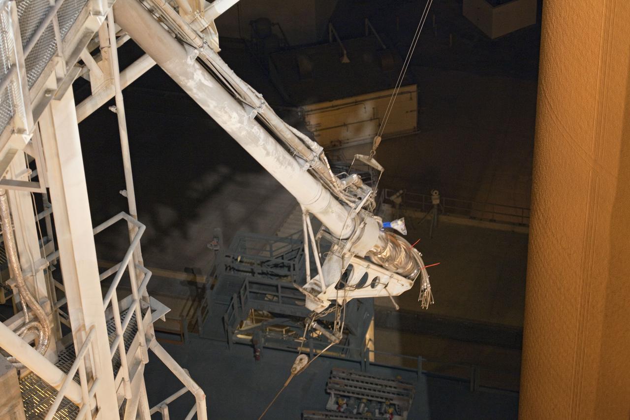 CAPE CANAVERAL, Fla. -- On Launch Pad 39A at NASA's Kennedy Space Center in Florida, the vent line is detached from the ground umbilical carrier plate (GUCP) on the bright-orange external fuel tank.  Next, the GUCP's 7-inch quick disconnect will be removed. A hydrogen gas leak at that location during tanking for space shuttle Discovery's STS-133 mission to the International Space Station caused the launch attempt to be scrubbed Nov. 5. The GUCP will be examined to determine the cause of the hydrogen leak and then repaired. The GUCP is the overboard vent to the pad and the flame stack where the vented hydrogen is burned off. Discovery's next launch attempt is no earlier than Nov. 30 at 4:02 a.m. EST.    For more information on STS-133, visit www.nasa.gov/mission_pages/shuttle/shuttlemissions/sts133/. Photo credit: NASA/Frankie Martin
