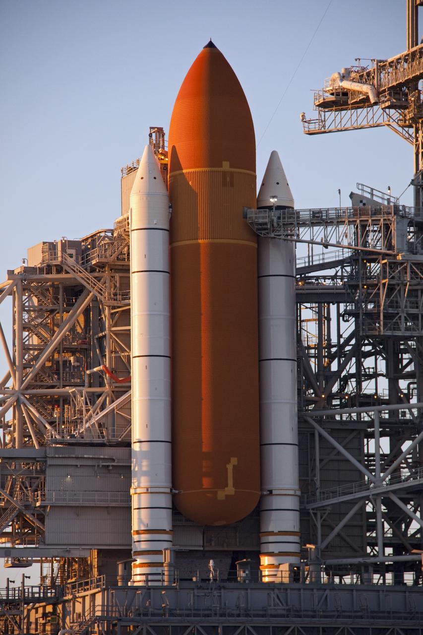 CAPE CANAVERAL, Fla. -- As the sun rises over Launch Pad 39A at NASA's Kennedy Space Center in Florida, preparations to remove the ground umbilical carrier plate's (GUCP) 7-inch quick disconnect are under way. A hydrogen gas leak at that location on the external fuel tank during tanking for space shuttle Discovery's STS-133 mission to the International Space Station caused the launch attempt to be scrubbed Nov. 5. The GUCP will be examined to determine the cause of the hydrogen leak and then repaired. The GUCP is the overboard vent to the pad and the flame stack where the vented hydrogen is burned off. Discovery's next launch attempt is no earlier than Nov. 30 at 4:02 a.m. EST. For more information on STS-133, visit www.nasa.gov/mission_pages/shuttle/shuttlemissions/sts133/. Photo credit: NASA/Troy Cryder
