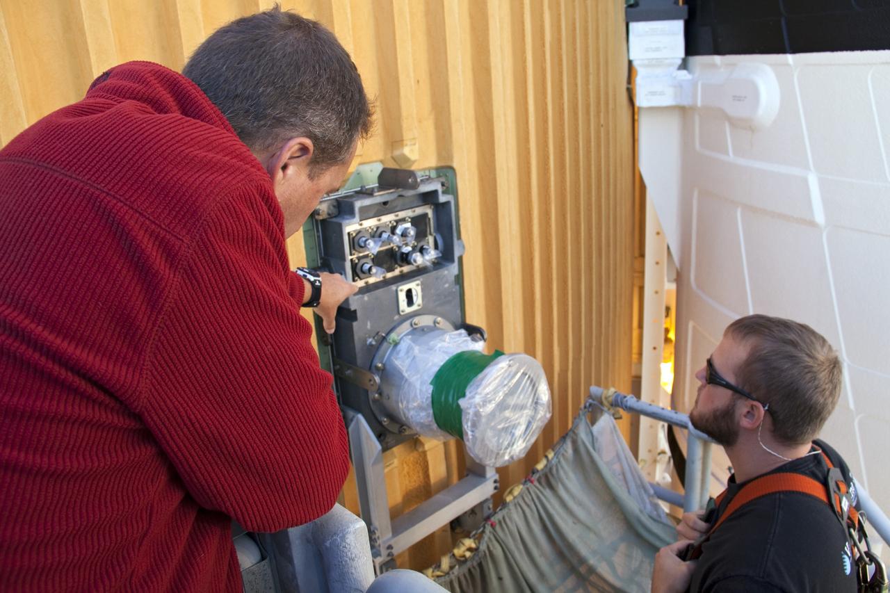 CAPE CANAVERAL, Fla. -- On Launch Pad 39A at NASA's Kennedy Space Center in Florida, workers prepare to remove the ground umbilical carrier plate's (GUCP) 7-inch quick disconnect. A hydrogen gas leak at that location on the external fuel tank during tanking for space shuttle Discovery's STS-133 mission to the International Space Station caused the launch attempt to be scrubbed Nov. 5. The GUCP will be examined to determine the cause of the hydrogen leak and then repaired. The GUCP is the overboard vent to the pad and the flame stack where the vented hydrogen is burned off. Discovery's next launch attempt is no earlier than Nov. 30 at 4:02 a.m. EST. For more information on STS-133, visit www.nasa.gov/mission_pages/shuttle/shuttlemissions/sts133/. Photo credit: NASA/Troy Cryder