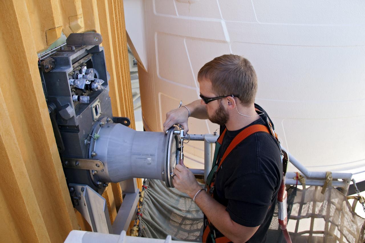 CAPE CANAVERAL, Fla. -- On Launch Pad 39A at NASA's Kennedy Space Center in Florida, a worker begins to remove the ground umbilical carrier plate's (GUCP) 7-inch quick disconnect. A hydrogen gas leak at that location on the external fuel tank during tanking for space shuttle Discovery's STS-133 mission to the International Space Station caused the launch attempt to be scrubbed Nov. 5. The GUCP will be examined to determine the cause of the hydrogen leak and then repaired. The GUCP is the overboard vent to the pad and the flame stack where the vented hydrogen is burned off. Discovery's next launch attempt is no earlier than Nov. 30 at 4:02 a.m. EST.        For more information on STS-133, visit www.nasa.gov/mission_pages/shuttle/shuttlemissions/sts133/. Photo credit: NASA/Troy Cryder