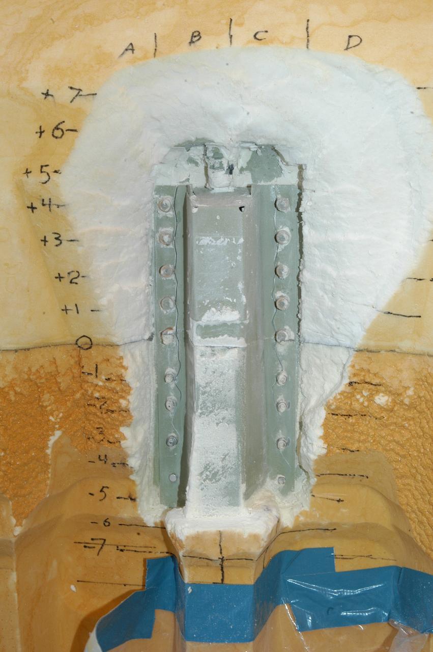 CAPE CANAVERAL, Fla. -- During the removal of external fuel tank foam insulation on Launch Pad 39A at NASA's Kennedy Space Center in Florida, technicians identified two cracks, each about 9 inches long, on a section of the tank’s metal exterior. The foam cracked during initial loading operations for space shuttle Discovery’s launch attempt on Nov. 5. The cracks are on one of the stringers, which are the composite aluminum ribs located vertically on the tank’s intertank area. Engineers will review images of the cracks to determine the best possible repair method, which would be done at the pad. Discovery's next launch attempt is no earlier than Nov. 30 at 4:02 a.m. EST.        For more information on STS-133, visit www.nasa.gov/mission_pages/shuttle/shuttlemissions/sts133/. Photo credit: NASA