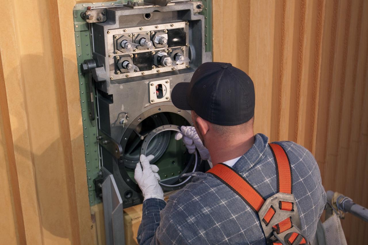 CAPE CANAVERAL, Fla. -- On Launch Pad 39A at NASA's Kennedy Space Center in Florida, workers remove the seal from the ground umbilical carrier plate (GUCP). A hydrogen gas leak at that location on the external fuel tank during tanking for space shuttle Discovery's STS-133 mission to the International Space Station caused the launch attempt to be scrubbed Nov. 5. The GUCP will be examined to determine the cause of the hydrogen leak and then repaired. The GUCP is the overboard vent to the pad and the flame stack where the excess hydrogen is burned off.     For more information on STS-133, visit www.nasa.gov/mission_pages/shuttle/shuttlemissions/sts133/. Photo credit: NASA/Jack Pfaller