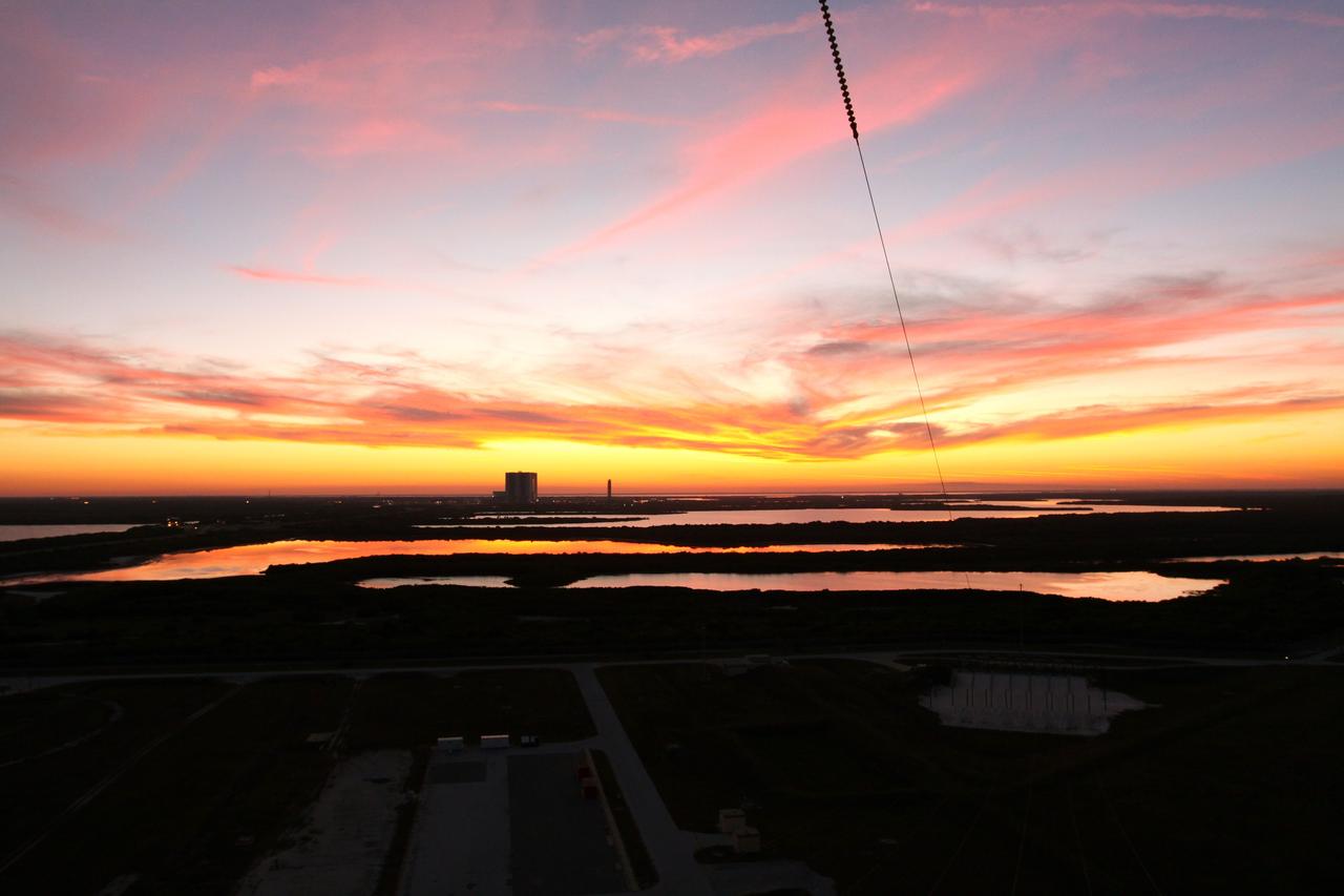 CAPE CANAVERAL, Fla. -- Taken from Launch Pad 39A at NASA's Kennedy Space Center in Florida, the sun sets, casting beautiful hues on the center's many bodies of water and shadowing the vast marshland, Vehicle Assembly Building and NASA's new mobile launcher.     Photo credit: NASA/Jack Pfaller