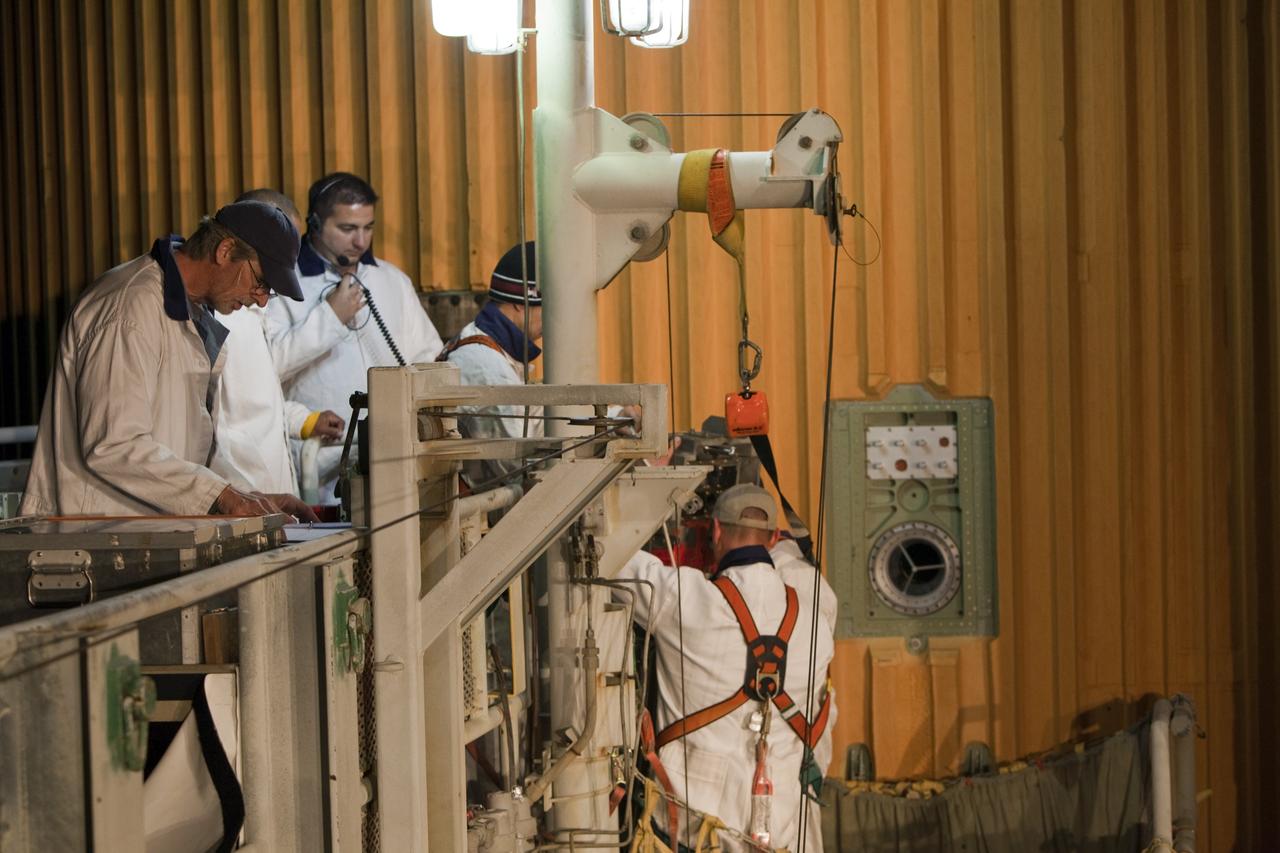 CAPE CANAVERAL, Fla. -- On Launch Pad 39A at NASA's Kennedy Space Center in Florida, the ground umbilical carrier plate (GUCP) is removed from space shuttle Discovery's external fuel tank. A hydrogen gas leak at that location during tanking for Discovery's STS-133 mission to the International Space Station caused the launch attempt to be scrubbed Nov. 5. The GUCP will be examined to determine the cause of the hydrogen leak and then repaired. The GUCP is the overboard vent to the pad and the flame stack where the excess hydrogen is burned off.       For more information on STS-133, visit www.nasa.gov/mission_pages/shuttle/shuttlemissions/sts133/. Photo credit: NASA/Dimitri Gerondidakis