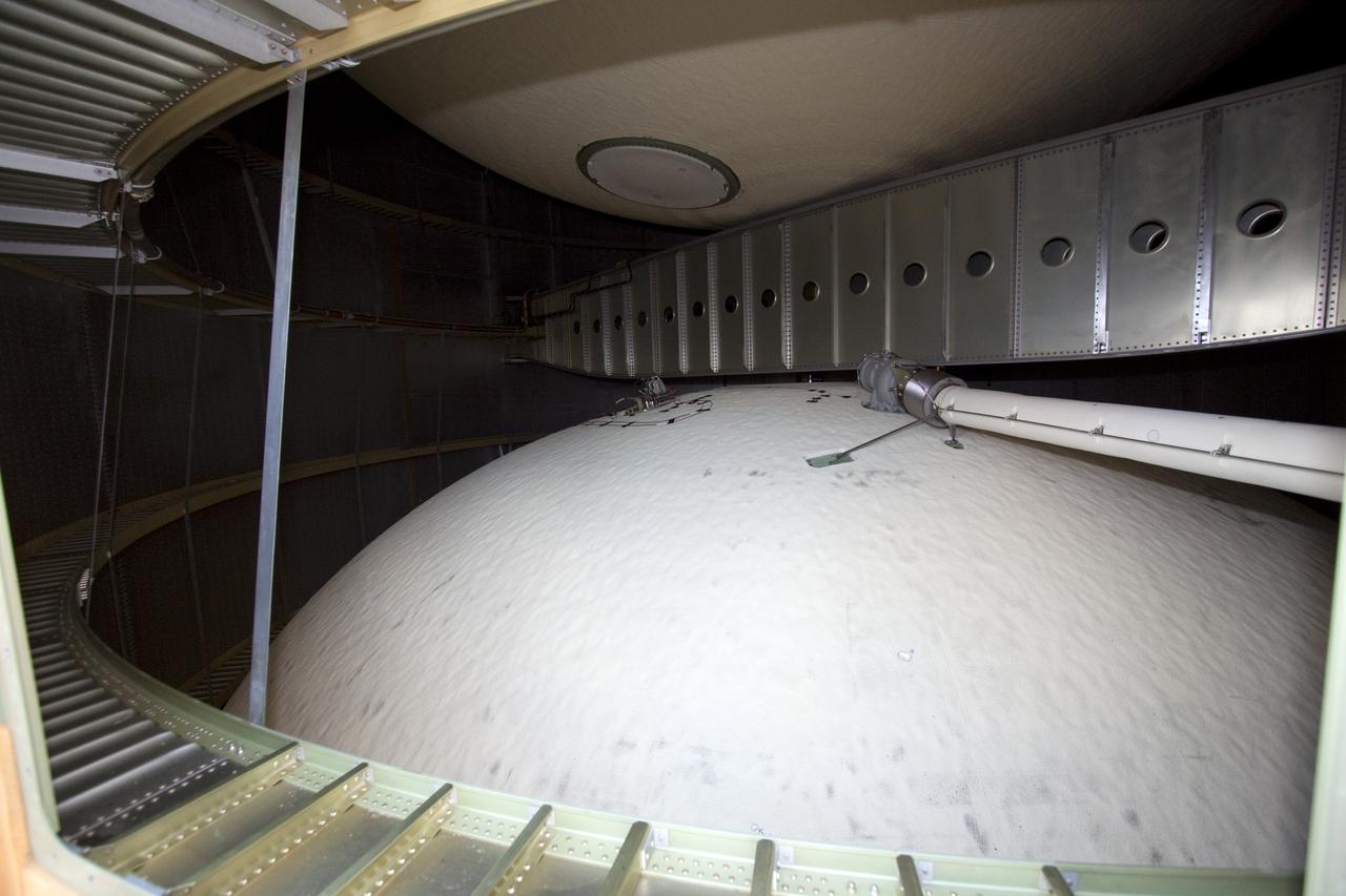 CAPE CANAVERAL, Fla. -- On Launch Pad 39A at NASA's Kennedy Space Center in Florida, this view gives  a look inside the intertank of space shuttle Discovery's external fuel tank. The intertank is unpressurized and holds most of the tank's electrical components. It sits between the liquid hydrogen tank, below, and liquid oxygen tank, above. Technicians will be working inside the intertank to further analyze two cracks that were found on the tank’s metal exterior. The foam cracked during initial loading operations for space shuttle Discovery’s launch attempt on Nov. 5. The cracks are on one of the stringers, which are the composite aluminum ribs located vertically on the intertank area.         Discovery's next launch attempt is no earlier than Nov. 30 at 4:02 a.m. EST. For more information on STS-133, visit www.nasa.gov/mission_pages/shuttle/shuttlemissions/sts133/. Photo credit: NASA/Jack Pfaller