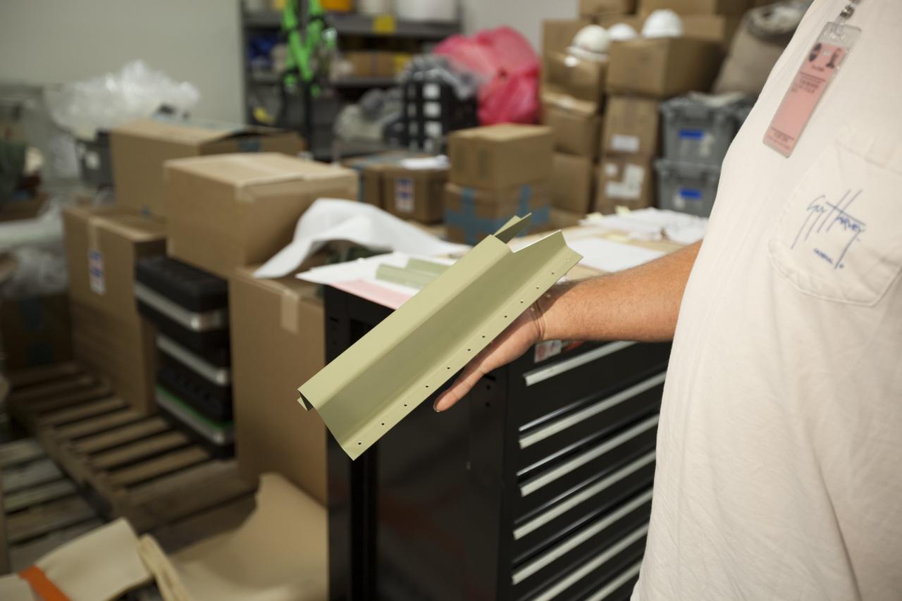 CAPE CANAVERAL, Fla. -- At NASA's Kennedy Space Center in Florida, a technician holds a new doubler that will be installed on a stringer of space shuttle Discovery's external fuel tank. Cracks were found on two stringers, which are the composite aluminum ribs located vertically on the intertank area, following loading operations for Discovery’s launch attempt on Nov. 5. Discovery's next launch attempt is no earlier than Nov. 30 at 4:02 a.m. EST. For more information on STS-133, visit www.nasa.gov/mission_pages/shuttle/shuttlemissions/sts133/. Photo credit: NASA/Dimitri Gerondidakis