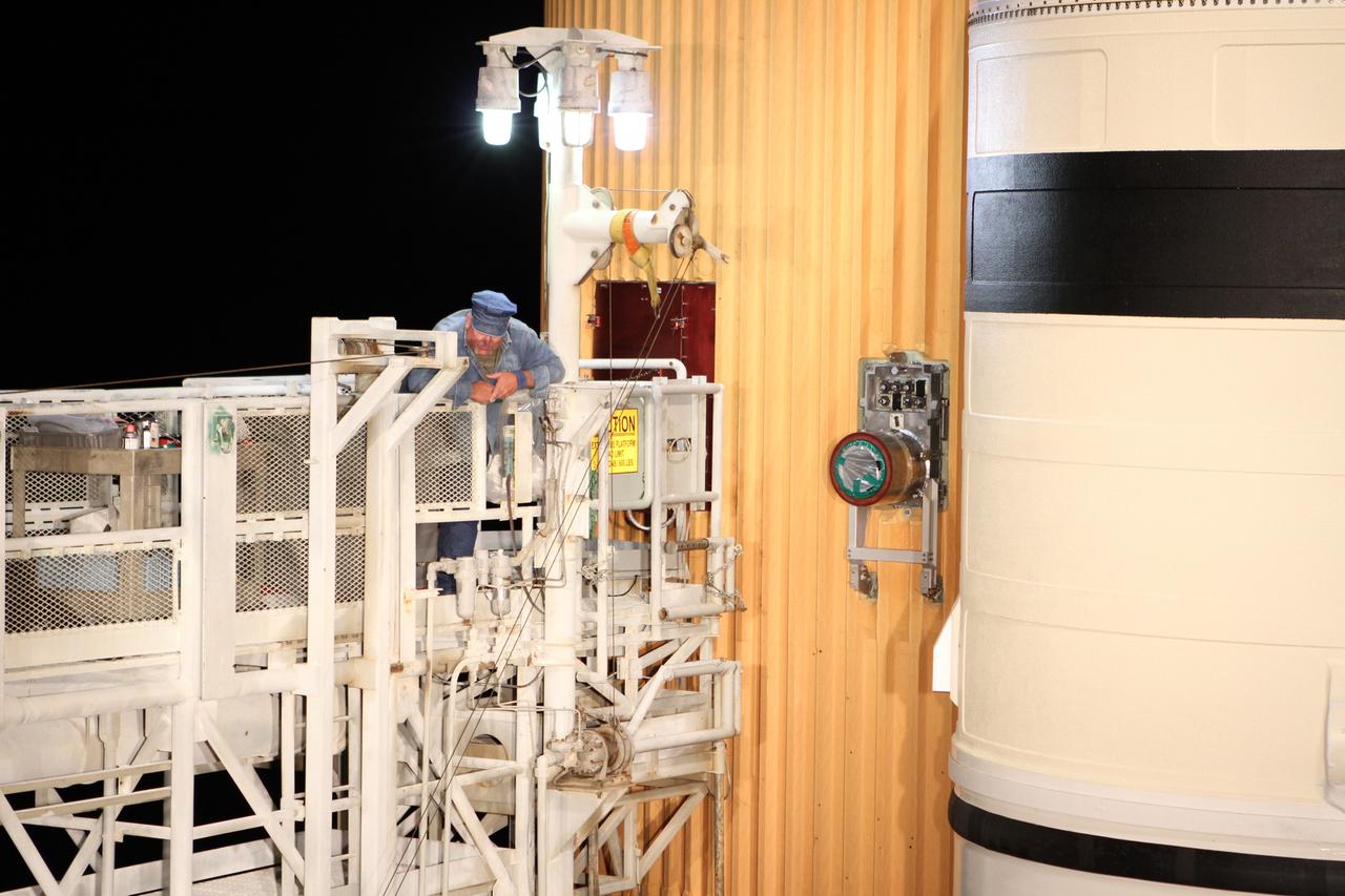 CAPE CANAVERAL, Fla. -- On Launch Pad 39A at NASA's Kennedy Space Center in Florida, preparations are under way to reattach the vent line to the ground umbilical carrier plate (GUCP) on space shuttle Discovery's external fuel tank. A hydrogen gas leak at that location during tanking for Discovery's STS-133 mission to the International Space Station caused the launch attempt to be scrubbed Nov. 5. The GUCP is the overboard vent to the pad and the flame stack where the excess hydrogen is burned off. Discovery's next launch attempt is no earlier than Nov. 30 at 4:02 a.m. EST. For more information on STS-133, visit www.nasa.gov/mission_pages/shuttle/shuttlemissions/sts133/. Photo credit: NASA/Ben Smegelsky