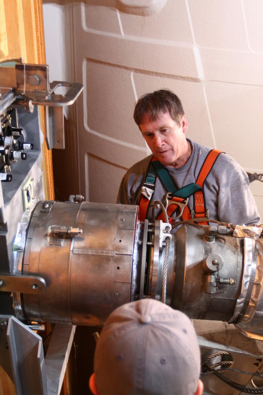 CAPE CANAVERAL, Fla. -- On Launch Pad 39A at NASA's Kennedy Space Center in Florida, technicians reattach the vent line to the ground umbilical carrier plate (GUCP) on space shuttle Discovery's external fuel tank. A hydrogen gas leak at that location during tanking for Discovery's STS-133 mission to the International Space Station caused the launch attempt to be scrubbed Nov. 5.     The GUCP is the overboard vent to the pad and the flame stack where the excess hydrogen is burned off. Discovery's next launch attempt is no earlier than Nov. 30 at 4:02 a.m. EST. For more information on STS-133, visit www.nasa.gov/mission_pages/shuttle/shuttlemissions/sts133/. Photo credit: NASA/Ben Smegelsky