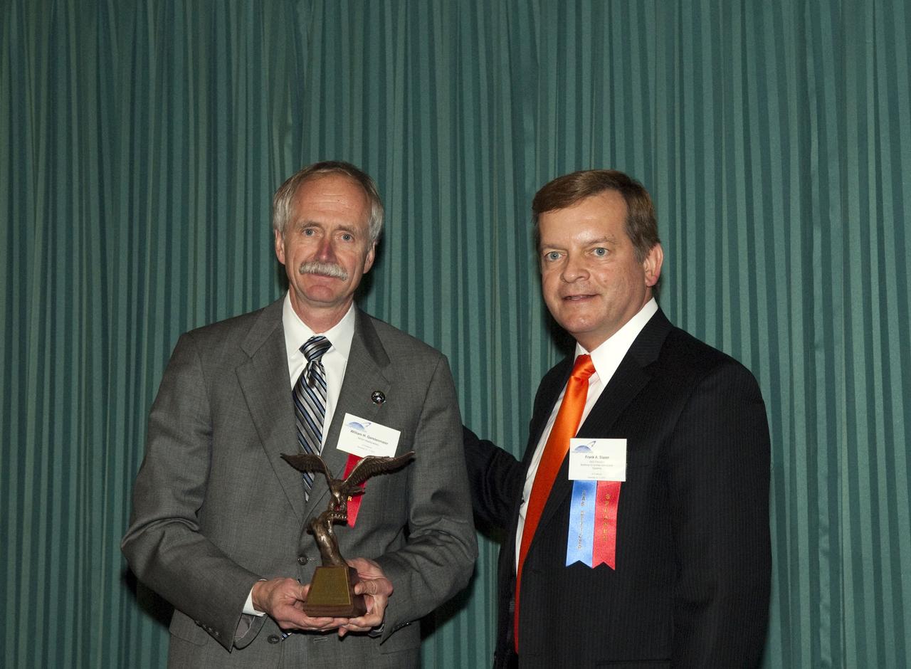 CAPE CANAVERAL, Fla. -- After being presented with the 2010 Space Flight award from the American Astronautical Society, NASA Associate Administrator for Space Operations Bill Gerstenmaier and Northrop Grumman/American Astronautical Society President Frank Slazer pose for a photo at the American Astronautical Society's 2010 National Conference held at the Radisson Resort at the Port in Cape Canaveral, Fla.          This year's conference was titled: International Space Station: The Next Decade - Utilization and Research. The conference was organized with the support of Kennedy and sponsored by The Boeing Company, Honeywell International Inc., Northrop Grumman Corp., Space Florida and the Universities Space Research Association (USRA). Photo credit: NASA/Jim Grossmann