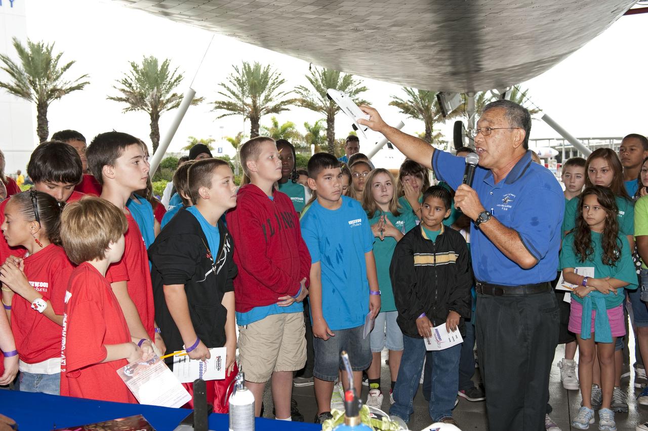 CAPE CANAVERAL, Fla. -- Brevard County sixth-graders participate in the eighth annual Space Week at the Kennedy Space Center Visitor Complex in Florida. Here, Herbert Yamada, an engineer with Lockheed Martin, teaches students about NASA's space shuttle.       About 5,000 students will participate throughout the 11-day event, which contains fun space exploration activities designed to emphasize the importance of science, technology, engineering and math (STEM). Space Week is sponsored by NASA Education, Brevard Public Schools, Delaware North Companies Parks and Resorts, and the Florida Chapter of the National Space Club. Photo Credit: NASA/Kim Shiflett