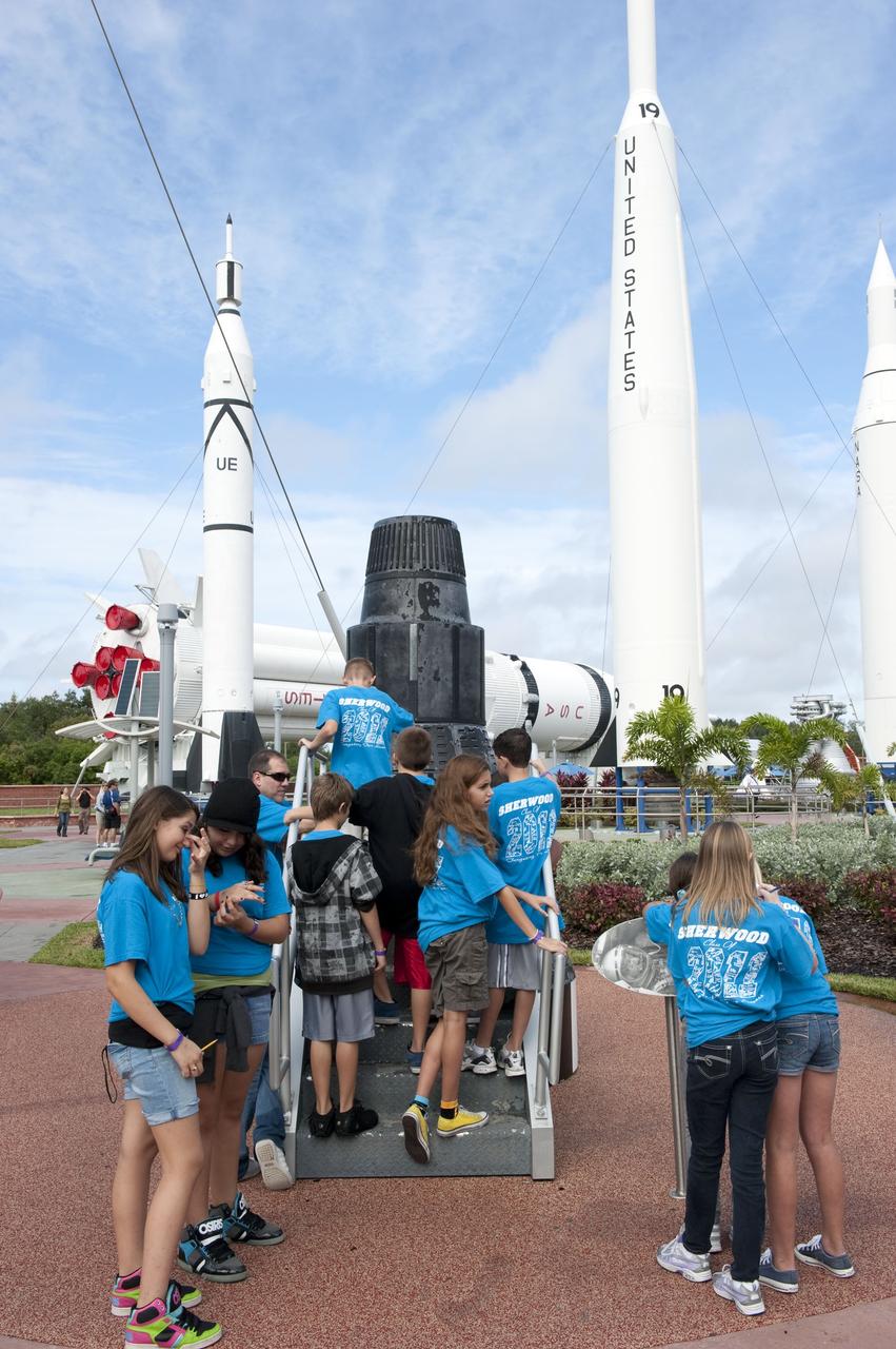 CAPE CANAVERAL, Fla. -- Brevard County sixth-graders participate in the eighth annual Space Week at the Kennedy Space Center Visitor Complex in Florida. Here, the students climb into a Mercury capsule in the complex's Rocket Garden.       About 5,000 students will participate throughout the 11-day event, which contains fun space exploration activities designed to emphasize the importance of science, technology, engineering and math (STEM). Space Week is sponsored by NASA Education, Brevard Public Schools, Delaware North Companies Parks and Resorts, and the Florida Chapter of the National Space Club. Photo Credit: NASA/Kim Shiflett