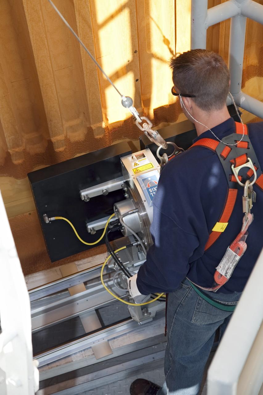 CAPE CANAVERAL, Fla. -- An engineer uses a backscatter device to examine space shuttle Discovery's external fuel tank on Launch Pad 39A at NASA's Kennedy Space Center in Florida. The device bounces radiation off the tank, allowing technicians to see under the tank's foam insulation. The foam cracked during initial loading operations for Discovery’s STS-133 launch attempt on Nov. 5, and technicians later identified two cracked stringers, which are the composite aluminum ribs located vertically on the tank’s intertank area. Those two stringers have been replaced and reinforced with doublers, which are shaped metal pieces twice as thick as the original stringers.      Launch is no earlier than Dec. 17 at 8:51 p.m. EST. For more information on STS-133, visit www.nasa.gov/mission_pages/shuttle/shuttlemissions/sts133/. Photo credit: NASA/Frank Michaux