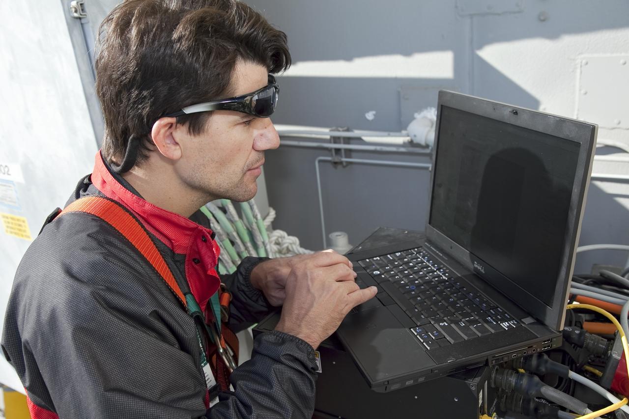 CAPE CANAVERAL, Fla. -- An engineer examines images of space shuttle Discovery's external fuel tank taken from a backscatter device on Launch Pad 39A at NASA's Kennedy Space Center in Florida. The device bounces radiation off the tank, allowing technicians to see under the tank's foam insulation. The foam cracked during initial loading operations for Discovery’s STS-133 launch attempt on Nov. 5, and technicians later identified two cracked stringers, which are the composite aluminum ribs located vertically on the tank’s intertank area. Those two stringers have been replaced and reinforced with doublers, which are shaped metal pieces twice as thick as the original stringers.    Launch is no earlier than Dec. 17 at 8:51 p.m. EST. For more information on STS-133, visit www.nasa.gov/mission_pages/shuttle/shuttlemissions/sts133/. Photo credit: NASA/Frank Michaux