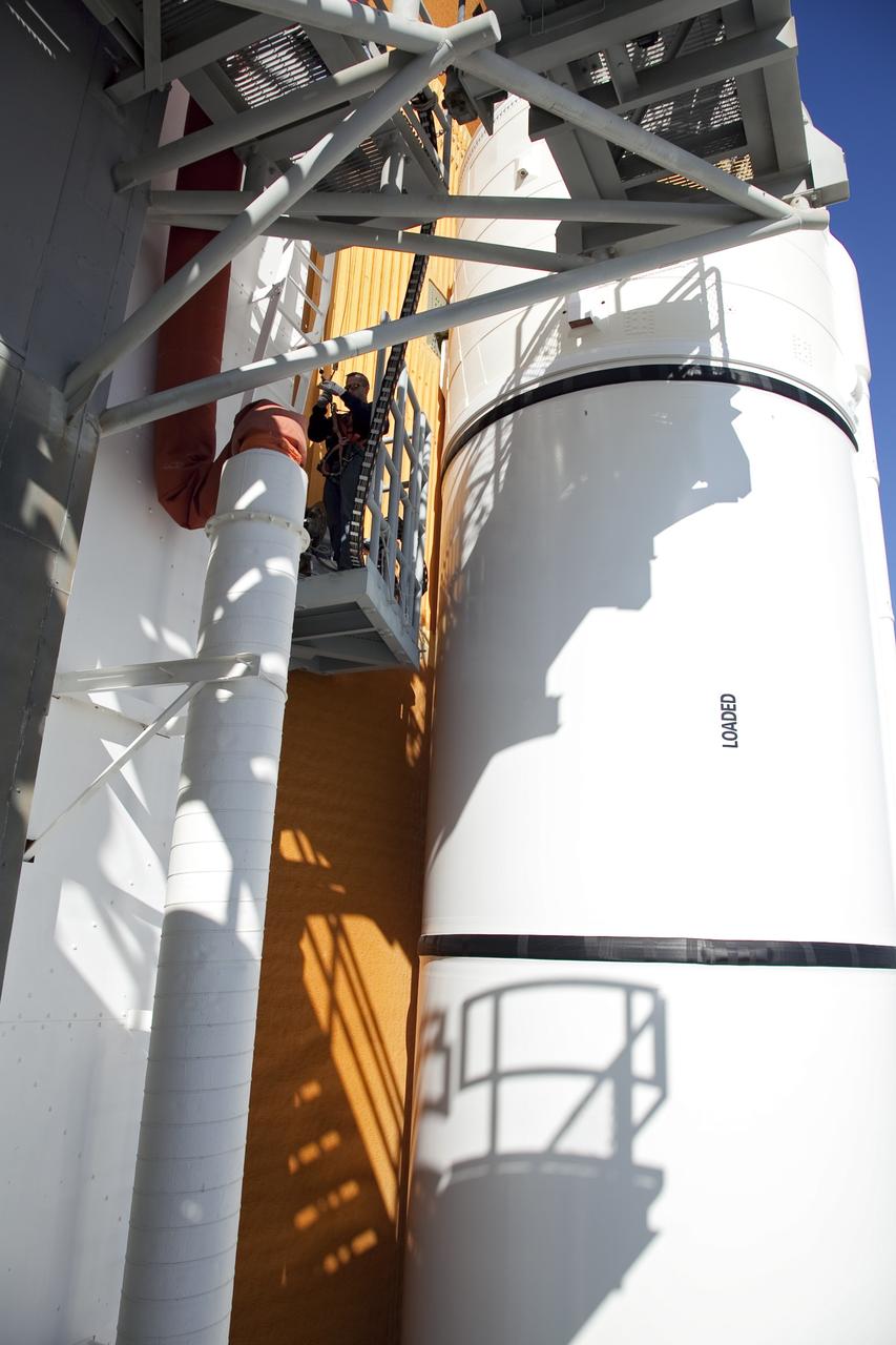 CAPE CANAVERAL, Fla. -- An engineer uses a backscatter device to examine space shuttle Discovery's external fuel tank on Launch Pad 39A at NASA's Kennedy Space Center in Florida. The device bounces radiation off the tank, allowing technicians to see under the tank's foam insulation. The foam cracked during initial loading operations for Discovery’s STS-133 launch attempt on Nov. 5, and technicians later identified two cracked stringers, which are the composite aluminum ribs located vertically on the tank’s intertank area. Those two stringers have been replaced and reinforced with doublers, which are shaped metal pieces twice as thick as the original stringers.        Launch is no earlier than Dec. 17 at 8:51 p.m. EST. For more information on STS-133, visit www.nasa.gov/mission_pages/shuttle/shuttlemissions/sts133/. Photo credit: NASA/Frank Michaux
