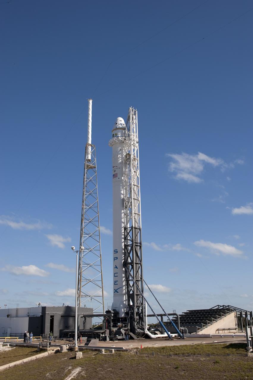 CAPE CANAVERAL, Fla. -- The SpaceX Falcon 9 rocket awaits a static fire test on Space Launch Complex-40 at Cape Canaveral Air Force Station, in which all nine Merlin engines will fire at once. The engines use rocket-grade kerosene and liquid oxygen to produce 1 million pounds of thrust. After the test, SpaceX will conduct a thorough review of all data as engineers make final preparations for the first launch of the Commercial Orbital Transportation Services (COTS) Dragon spacecraft to low Earth orbit atop the Falcon 9.          This first stage firing is part of a full launch dress rehearsal, which will end after the engines fire at full power for two seconds, with only the hold-down system restraining the rocket from flight. Photo credit: NASA/Tony Gray and Kevin O'Connell