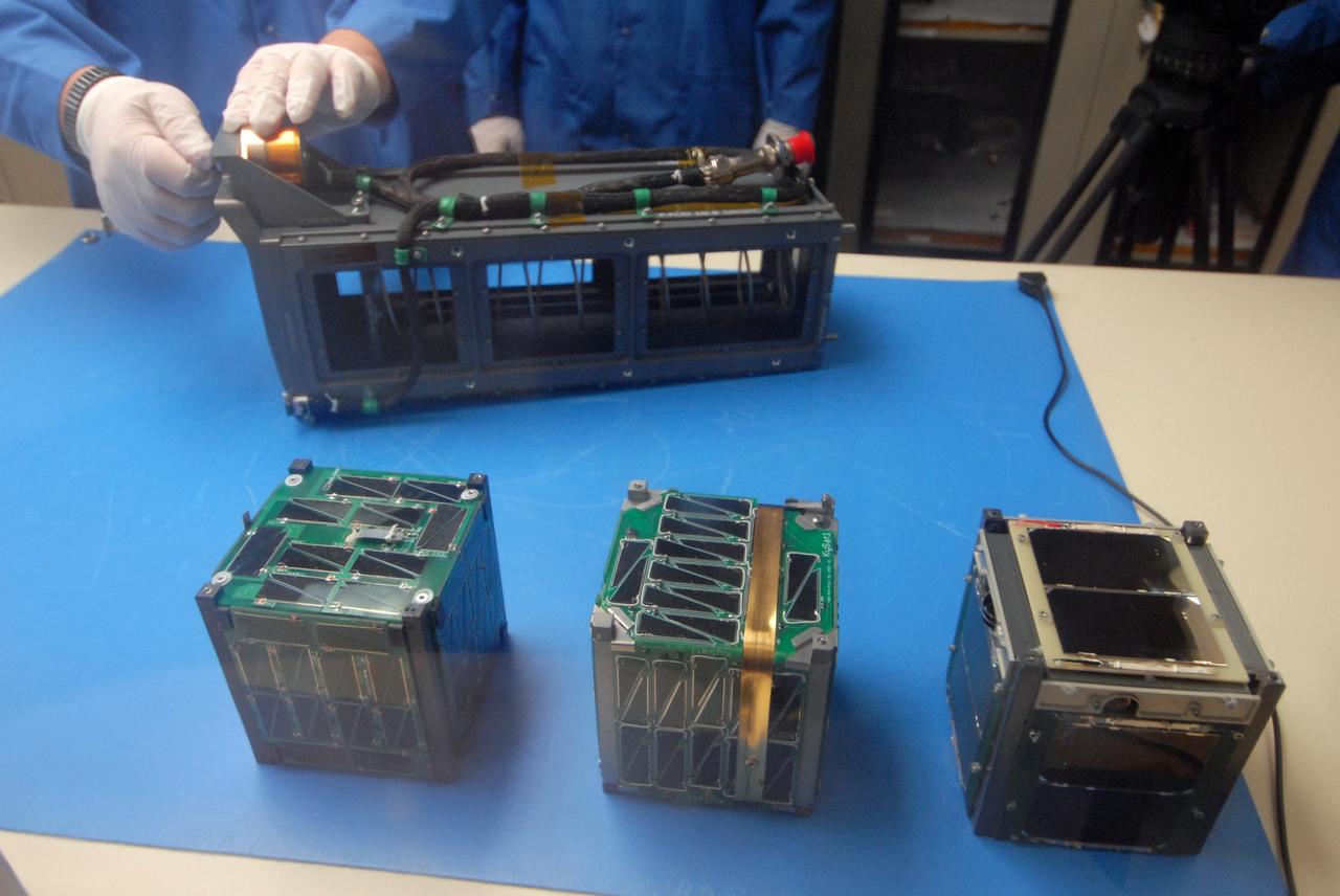 San Luis Obispo, Calif. -- 101116-F-8290C-045 -- Students at California Polytechnic State University Cal Poly prepare to integrate miniature research satellites called CubeSats into a Poly Picosatellite Orbital Deployer PPOD container. The PPOD and CubeSat Project were developed by Cal Poly and Stanford University’s Space Systems Development Lab for use on NASA’s Educational Launch of Nanosatellite ELaNa missions. Each CubeSat measures about 4-inches cubed and is about the same volume as a quart. The CubeSats weigh about 2.2 pounds, must conform to standard aerospace materials and must operate without propulsion.          The satellites are being prepared to launch with NASA's Glory spacecraft aboard an Orbital Sciences Corp. Taurus XL rocket, targeted to lift off Feb. 23, 2011, from Vandenberg's Space Launch Complex 576-E. Glory is scheduled to collect data on the properties of aerosols and black carbon from its place in low Earth orbit. It also will help scientists understand how the sun's irradiance affects Earth's climate. Photo credit: U.S. Air Force/Jerry E. Clemens Jr.