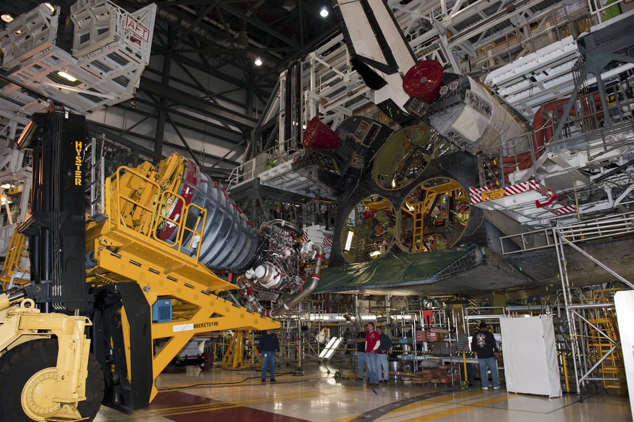 CAPE CANAVERAL, Fla. -- In Orbiter Processing Facility-1 at NASA's Kennedy Space Center in Florida, a Hyster forklift moves the first of three space shuttle main engines closer to space shuttle Atlantis for installation. Each engine is 14 feet long, weighs about 6,700 pounds, and is 7.5 feet in diameter at the end of the nozzle. This is the final planned engine installation for the Space Shuttle Program.            Atlantis is being prepared for the "launch on need," or potential rescue mission, for the final planned shuttle flight, Endeavour's STS-134 mission. For more information, visit www.nasa.gov/shuttle. Photo credit: NASA/Kim Shiflett