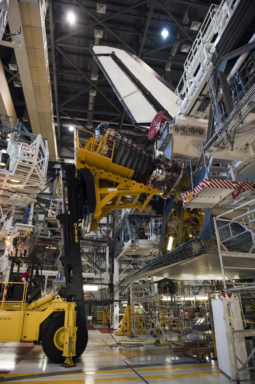 CAPE CANAVERAL, Fla. -- In Orbiter Processing Facility-1 at NASA's Kennedy Space Center in Florida, a Hyster forklift moves the first of three space shuttle main engines closer to space shuttle Atlantis for installation. Each engine is 14 feet long, weighs about 6,700 pounds, and is 7.5 feet in diameter at the end of the nozzle. This is the final planned engine installation for the Space Shuttle Program.            Atlantis is being prepared for the "launch on need," or potential rescue mission, for the final planned shuttle flight, Endeavour's STS-134 mission. For more information, visit www.nasa.gov/shuttle. Photo credit: NASA/Kim Shiflett