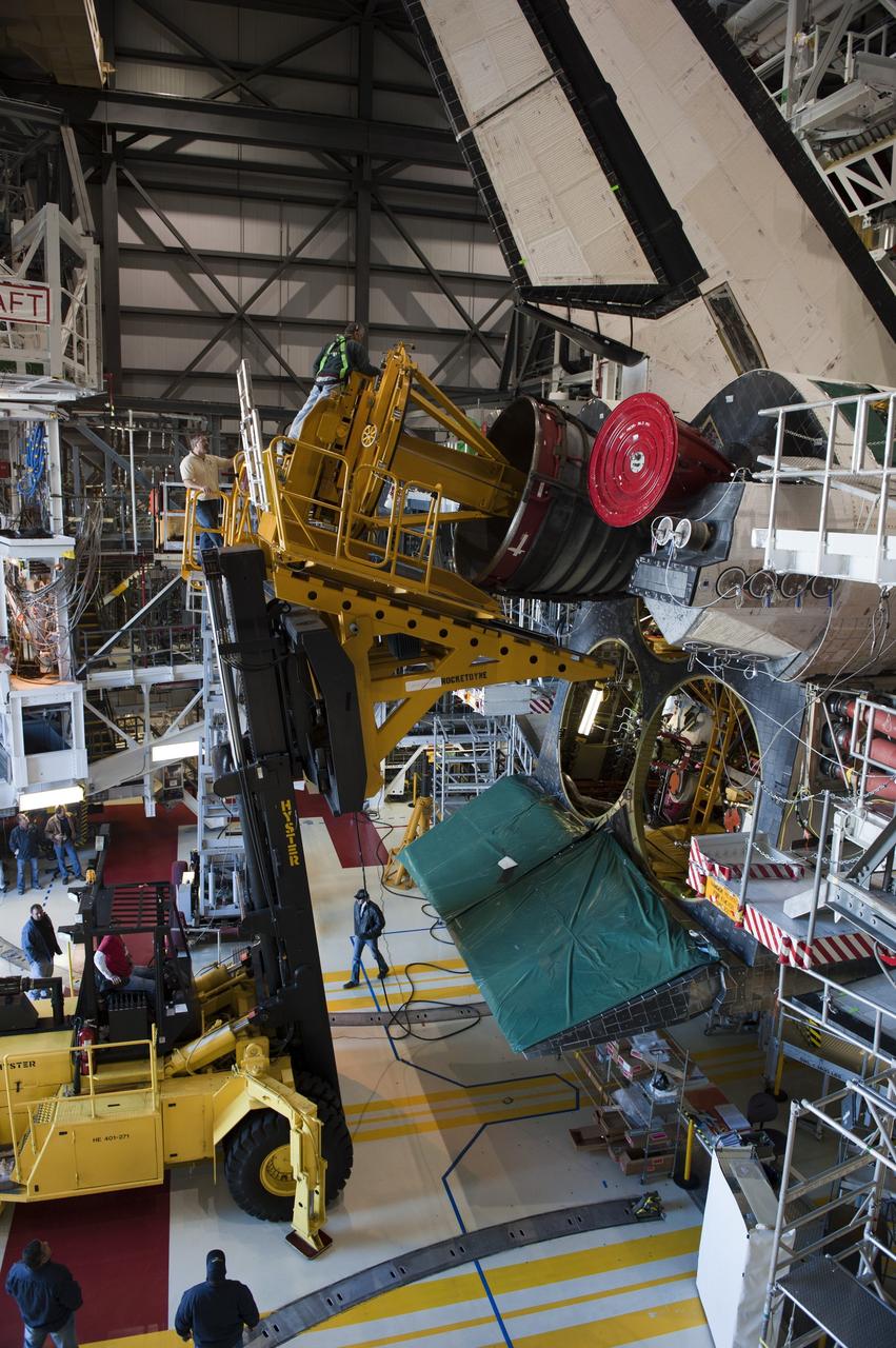 CAPE CANAVERAL, Fla. -- In Orbiter Processing Facility-1 at NASA's Kennedy Space Center in Florida, a Hyster forklift moves the first of three space shuttle main engines closer to space shuttle Atlantis for installation. Each engine is 14 feet long, weighs about 6,700 pounds, and is 7.5 feet in diameter at the end of the nozzle. This is the final planned engine installation for the Space Shuttle Program.            Atlantis is being prepared for the "launch on need," or potential rescue mission, for the final planned shuttle flight, Endeavour's STS-134 mission. For more information, visit www.nasa.gov/shuttle. Photo credit: NASA/Kim Shiflett