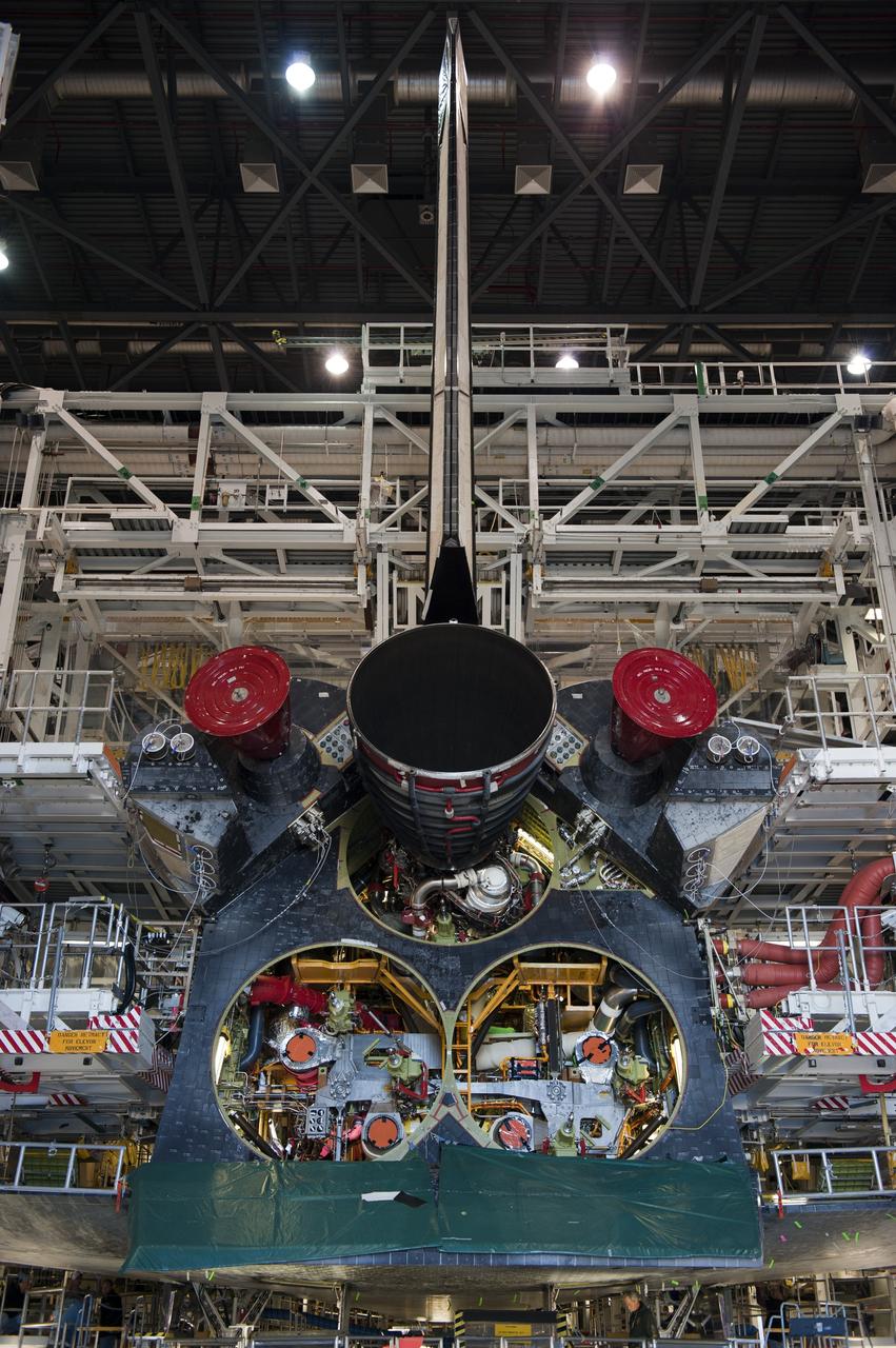 CAPE CANAVERAL, Fla. -- In Orbiter Processing Facility-1 at NASA's Kennedy Space Center in Florida, the first of three space shuttle main engines is installed in space shuttle Atlantis. Each engine is 14 feet long, weighs about 6,700 pounds, and is 7.5 feet in diameter at the end of the nozzle. This is the final planned engine installation for the Space Shuttle Program.          Atlantis is being prepared for the "launch on need," or potential rescue mission, for the final planned shuttle flight, Endeavour's STS-134 mission. For more information, visit www.nasa.gov/shuttle. Photo credit: NASA/Kim Shiflett