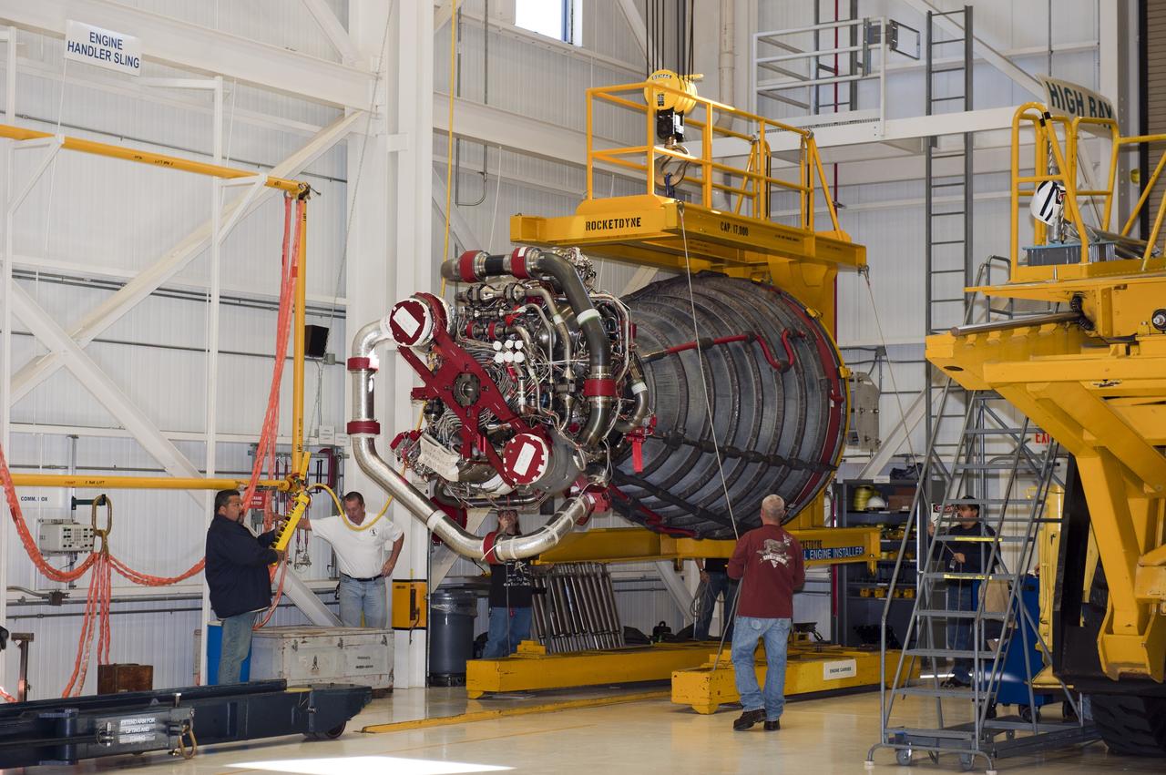 CAPE CANAVERAL, Fla. -- Workers in the Space Shuttle Main Engine (SSME) Shop at NASA's Kennedy Space Center in Florida get ready to raise the second of shuttle Atlantis' three main engines so it can be attached to a Hyster forklift. Then, the engine will be transported to Orbiter Processing Facility-1 where it will be installed in the shuttle. Each engine is 14 feet long, weighs about 6,700 pounds, and is 7.5 feet in diameter at the end of the nozzle. This is the final planned engine installation for the Space Shuttle Program.        Atlantis is being prepared for the "launch on need," or potential rescue mission, for the final planned shuttle flight, Endeavour's STS-134 mission. For more information, visit www.nasa.gov/shuttle. Photo credit: NASA/Kim Shiflett