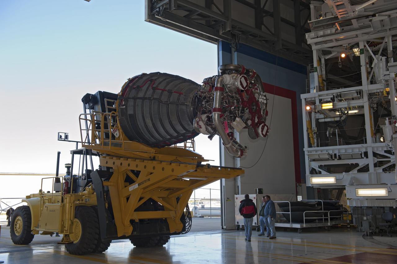 CAPE CANAVERAL, Fla. -- A Hyster forklift transporting the second of shuttle Atlantis' three main engines arrives at Orbiter Processing Facility-1 from the Space Shuttle Main Engine (SSME) Shop at NASA's Kennedy Space Center in Florida. There, the engine will be installed in the shuttle. Each engine is 14 feet long, weighs about 6,700 pounds, and is 7.5 feet in diameter at the end of the nozzle. This is the final planned engine installation for the Space Shuttle Program.    Atlantis is being prepared for the "launch on need," or potential rescue mission, for the final planned shuttle flight, Endeavour's STS-134 mission. For more information, visit www.nasa.gov/shuttle. Photo credit: NASA/Kim Shiflett