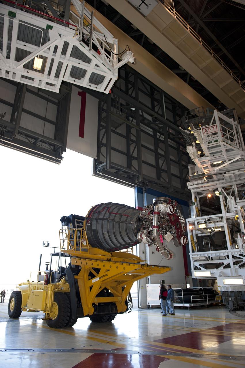 CAPE CANAVERAL, Fla. -- A Hyster forklift transporting the second of shuttle Atlantis' three main engines arrives at Orbiter Processing Facility-1 from the Space Shuttle Main Engine (SSME) Shop at NASA's Kennedy Space Center in Florida. There, the engine will be installed in the shuttle. Each engine is 14 feet long, weighs about 6,700 pounds, and is 7.5 feet in diameter at the end of the nozzle. This is the final planned engine installation for the Space Shuttle Program.      Atlantis is being prepared for the "launch on need," or potential rescue mission, for the final planned shuttle flight, Endeavour's STS-134 mission. For more information, visit www.nasa.gov/shuttle. Photo credit: NASA/Kim Shiflett
