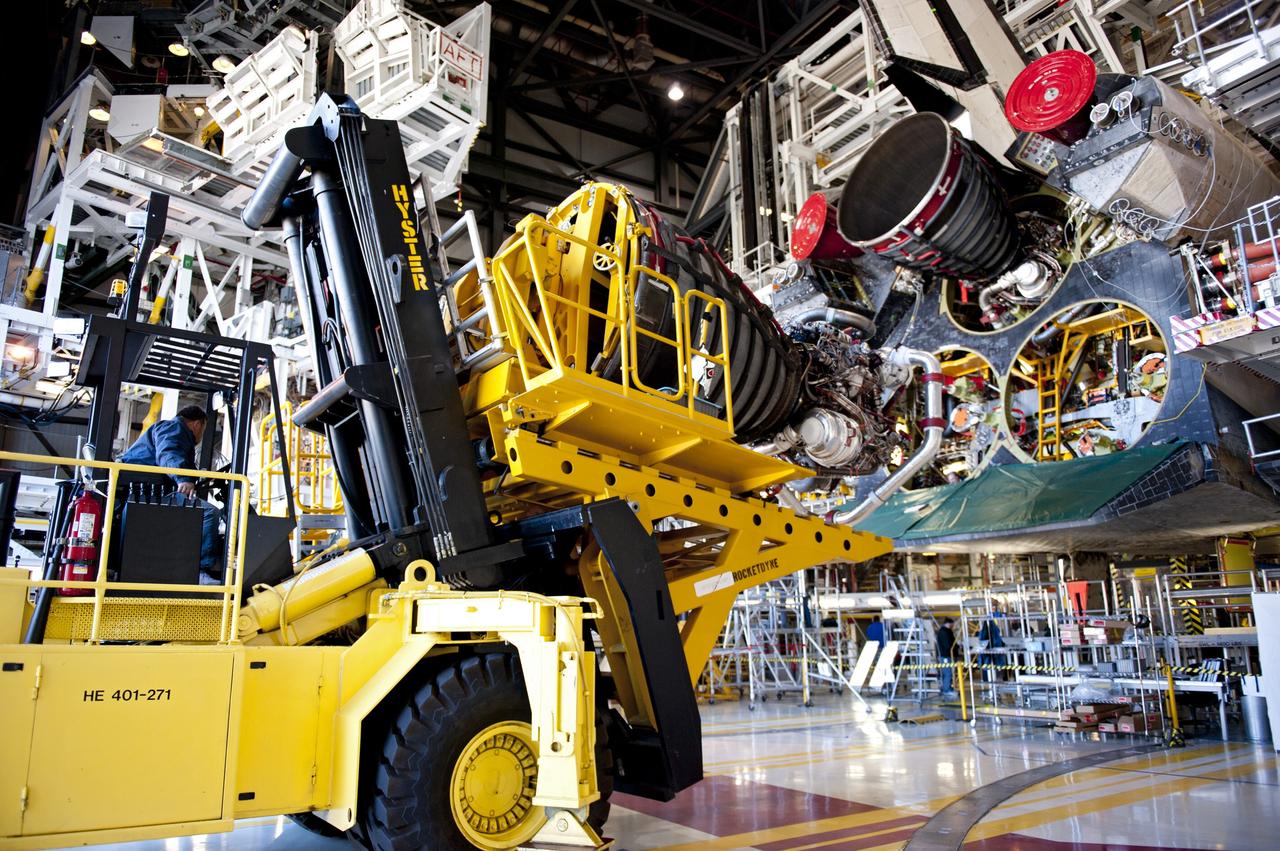 CAPE CANAVERAL, Fla. -- A Hyster forklift transporting the second of shuttle Atlantis' three main engines arrives at Orbiter Processing Facility-1 from the Space Shuttle Main Engine (SSME) Shop at NASA's Kennedy Space Center in Florida. There, the engine will be installed in the shuttle. Each engine is 14 feet long, weighs about 6,700 pounds, and is 7.5 feet in diameter at the end of the nozzle. This is the final planned engine installation for the Space Shuttle Program.    Atlantis is being prepared for the "launch on need," or potential rescue mission, for the final planned shuttle flight, Endeavour's STS-134 mission. For more information, visit www.nasa.gov/shuttle. Photo credit: NASA/Kim Shiflett