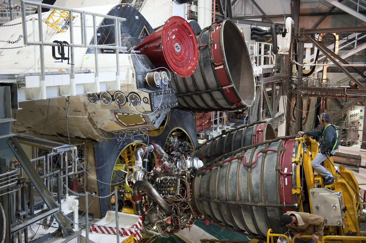 CAPE CANAVERAL, Fla. -- In Orbiter Processing Facility-1 at NASA's Kennedy Space Center in Florida, engine #2, the last of three space shuttle main engines is being installed in shuttle Atlantis.       Each engine is 14 feet long, weighs about 6,700 pounds, and is 7.5 feet in diameter at the end of the nozzle. This is the final planned engine installation for the Space Shuttle Program. Atlantis is being prepared for the "launch on need," or potential rescue mission, for the final planned shuttle flight, Endeavour's STS-134 mission. For more information, visit www.nasa.gov/shuttle. Photo credit: NASA/Kim Shiflett