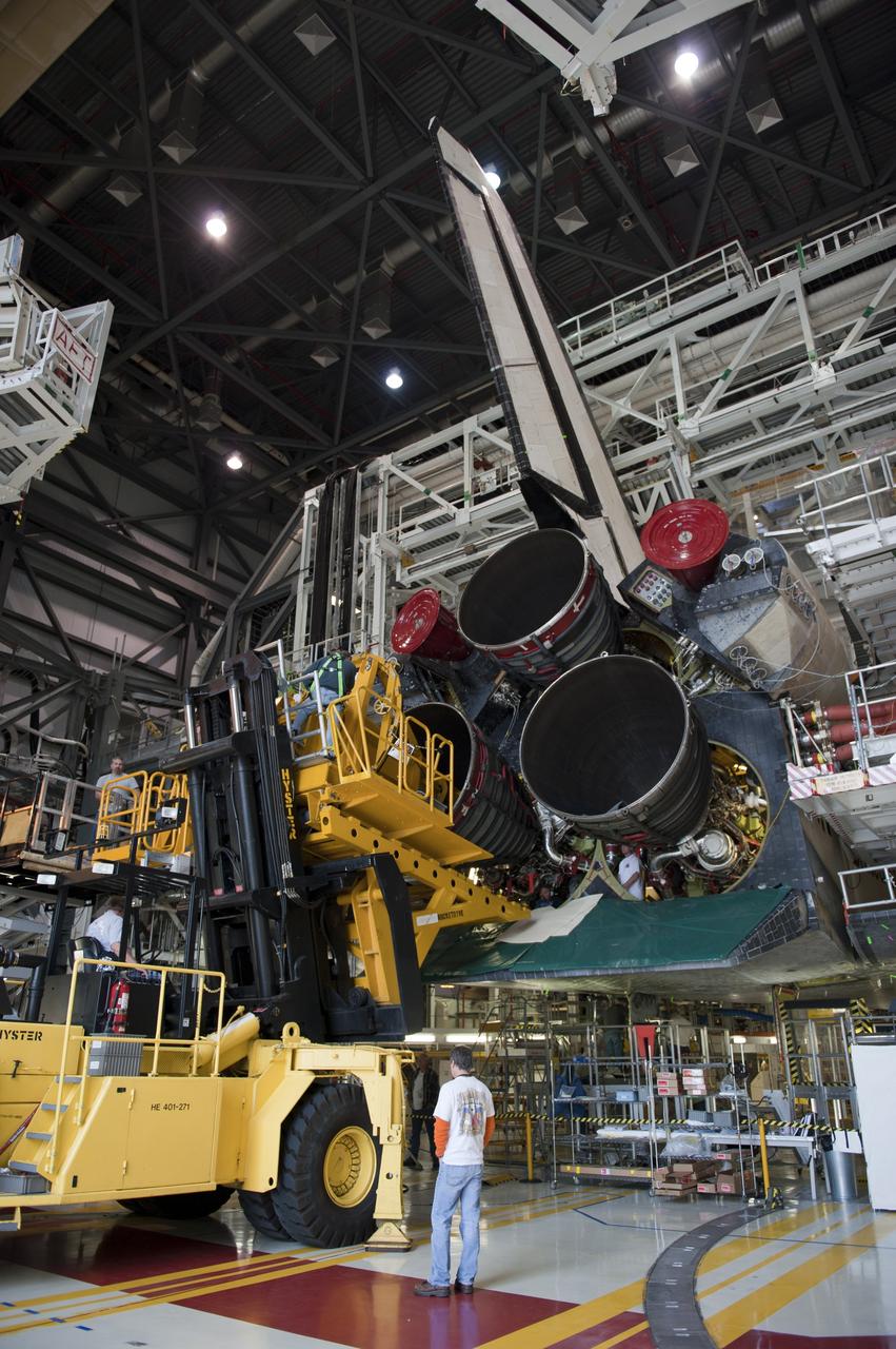 CAPE CANAVERAL, Fla. -- In Orbiter Processing Facility-1 at NASA's Kennedy Space Center in Florida, engine #2, the last of three space shuttle main engines is being installed in shuttle Atlantis.       Each engine is 14 feet long, weighs about 6,700 pounds, and is 7.5 feet in diameter at the end of the nozzle. This is the final planned engine installation for the Space Shuttle Program. Atlantis is being prepared for the "launch on need," or potential rescue mission, for the final planned shuttle flight, Endeavour's STS-134 mission. For more information, visit www.nasa.gov/shuttle. Photo credit: NASA/Kim Shiflett