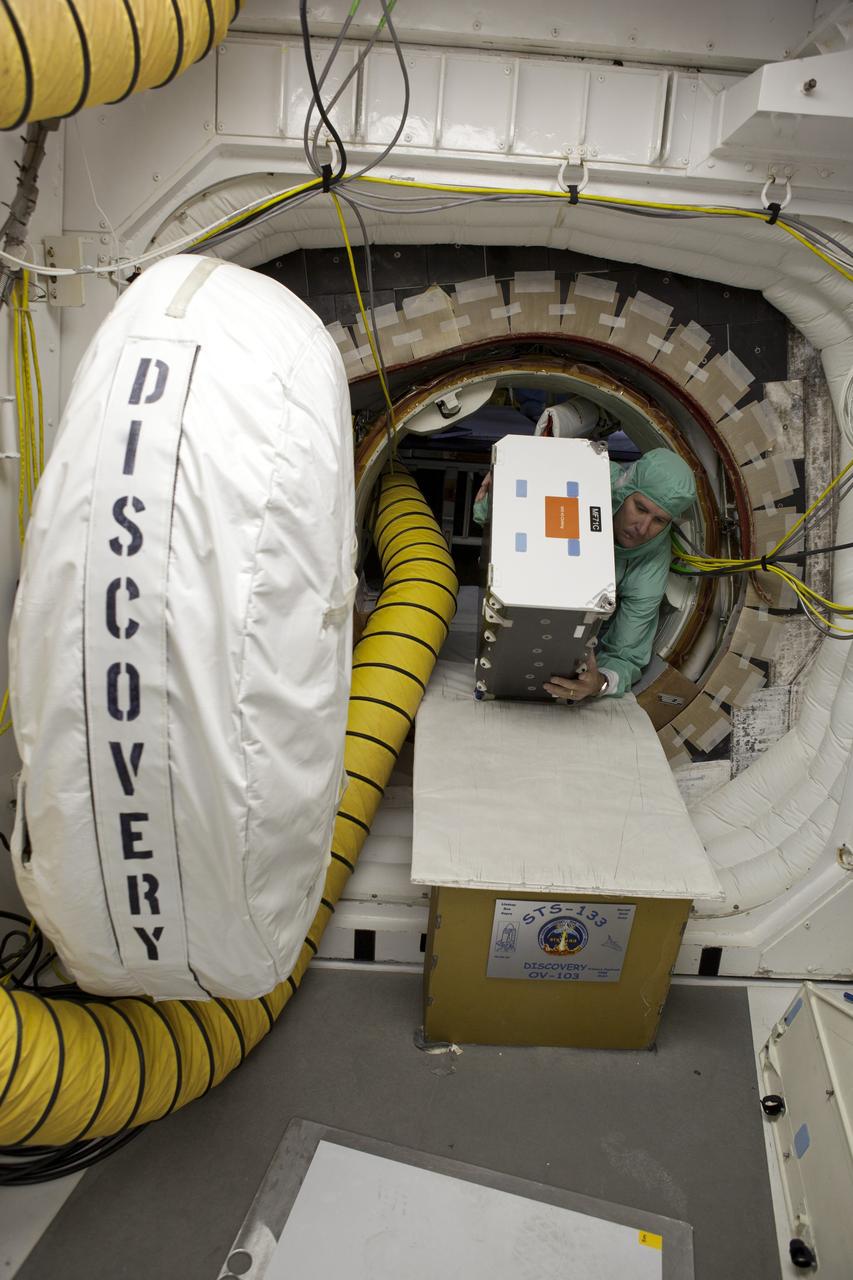 CAPE CANAVERAL, Fla. -- On Launch Pad 39A at NASA's Kennedy Space Center in Florida, technicians remove a few items from space shuttle Discovery's middeck payload, including food, prior to a tanking test planned for no earlier than Dec. 15. During the test, engineers will monitor what happens to the external fuel tank's newly replaced ground umbilical carrier plate (GUCP) and the intertank's stringers, which are 21-foot long, U-shaped aluminum brackets located on the intertank, during loading of cryogenic propellants. Technicians already installed environmental enclosures on the tank, removed foam and prepared the tank's skin for approximately 89 strain gauges and thermocouples.             Discovery's first launch attempt for STS-133 was scrubbed in early November due to a hydrogen gas leak at GUCP. The next launch opportunity is no earlier than Feb. 3, 2011. For more information on STS-133, visit www.nasa.gov/mission_pages/shuttle/shuttlemissions/sts133/. Photo credit: NASA/Ben Smegelsky