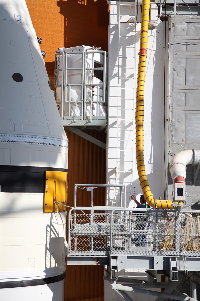CAPE CANAVERAL, Fla. -- Technicians prepare space shuttle Discovery's external fuel tank for a tanking test no earlier than Dec. 15 on Launch Pad 39A at NASA's Kennedy Space Center in Florida. During the test, engineers will monitor what happens to 21-foot long, U-shaped aluminum brackets, called stringers, located at the  intertank, as well as the  newly replaced ground umbilical carrier plate (GUCP), during the loading of cryogenic propellants. Teams already have installed environmental enclosures on the tank, removed foam and prepared the tank's skin for approximately 89 strain gauges and thermocouples.           Discovery's first launch attempt for STS-133 was scrubbed in early November due to a hydrogen gas leak at GUCP. The next launch opportunity is no earlier than Feb. 3, 2011. For more information on STS-133, visit www.nasa.gov/mission_pages/shuttle/shuttlemissions/sts133/. Photo credit: NASA/Frank Michaux