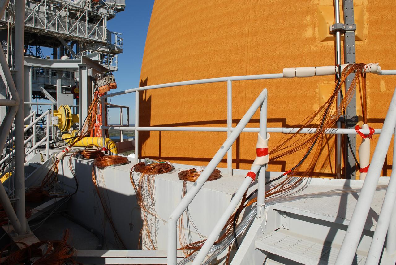 CAPE CANAVERAL, Fla. -- Space shuttle Discovery's external fuel tank is outfitted with approximately 89 strain gauges, thermocouples and wiring in preparation for a tanking test no earlier than Dec. 17 on Launch Pad 39A at NASA's Kennedy Space Center in Florida. During the test, engineers will monitor what happens to 21-foot long, U-shaped aluminum brackets, called stringers, located at the external tank's intertank area, as well as the newly replaced ground umbilical carrier plate (GUCP), during the loading of cryogenic propellants. Discovery's first launch attempt for STS-133 was scrubbed in early November due to a hydrogen gas leak at GUCP. The next launch opportunity is no earlier than Feb. 3, 2011. For more information on STS-133, visit www.nasa.gov/mission_pages/shuttle/shuttlemissions/sts133/. Photo credit: NASA/Jim Grossmann