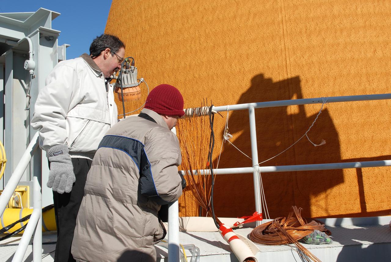 CAPE CANAVERAL, Fla. -- Technicians outfit space shuttle Discovery's external fuel tank with approximately 89 strain gauges, thermocouples and wiring in preparation for a tanking test no earlier than Dec. 17 on Launch Pad 39A at NASA's Kennedy Space Center in Florida. During the test, engineers will monitor what happens to 21-foot long, U-shaped aluminum brackets, called stringers, located at the external tank's intertank area, as well as the  newly replaced ground umbilical carrier plate (GUCP), during the loading of cryogenic propellants.     Discovery's first launch attempt for STS-133 was scrubbed in early November due to a hydrogen gas leak at GUCP. The next launch opportunity is no earlier than Feb. 3, 2011. For more information on STS-133, visit www.nasa.gov/mission_pages/shuttle/shuttlemissions/sts133/. Photo credit: NASA/Jim Grossmann