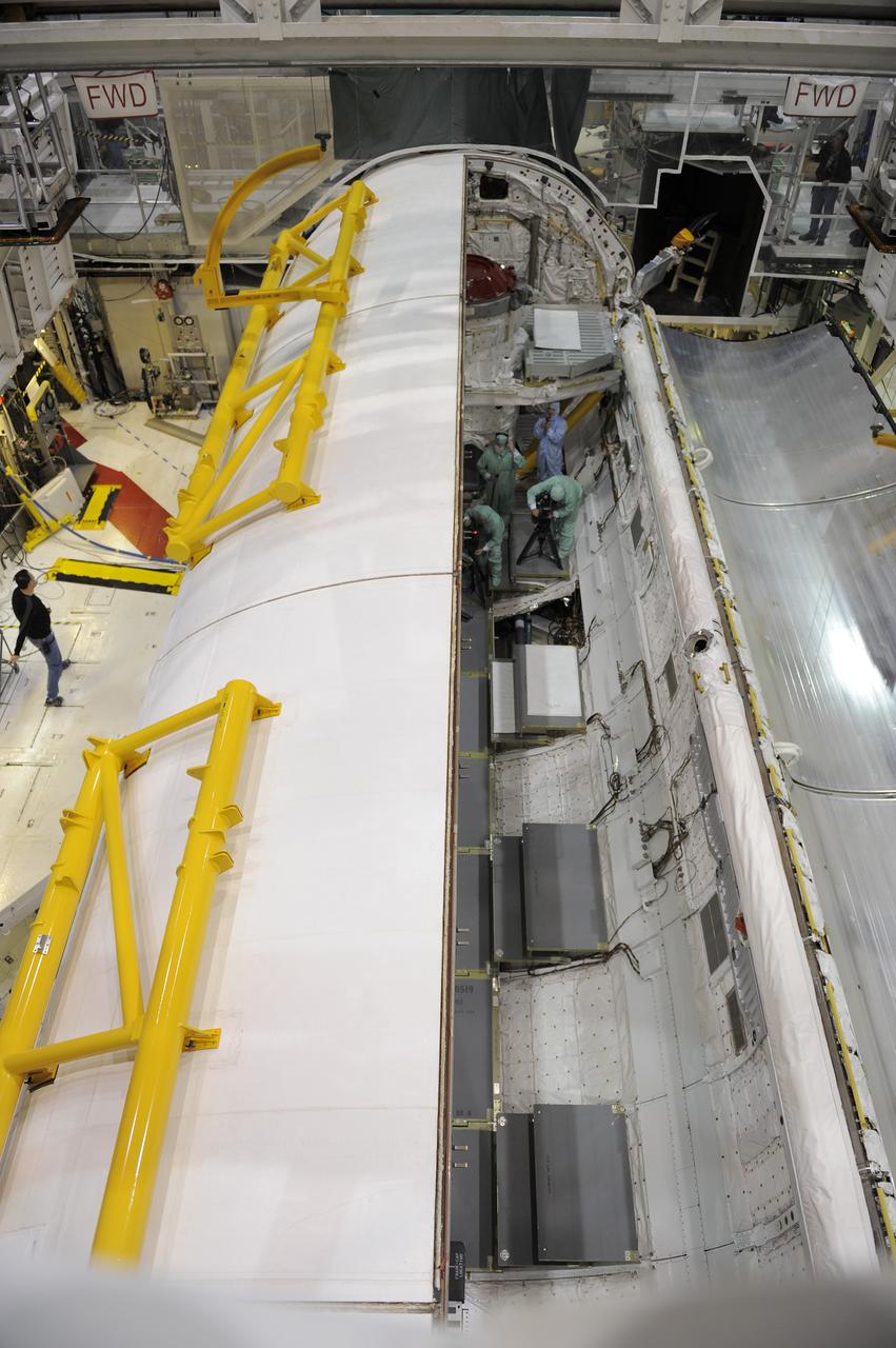 CAPE CANAVERAL, Fla. -- In Orbiter Processing Facility-1 at NASA's Kennedy Space Center in Florida, technicians close shuttle Atlantis' payload bay doors prior to the holidays.         Atlantis is being prepared for the "launch on need," or potential rescue mission, for the final planned shuttle flight, Endeavour's STS-134 mission. For more information, visit www.nasa.gov/shuttle. Photo credit: NASA/Kim Shiflett