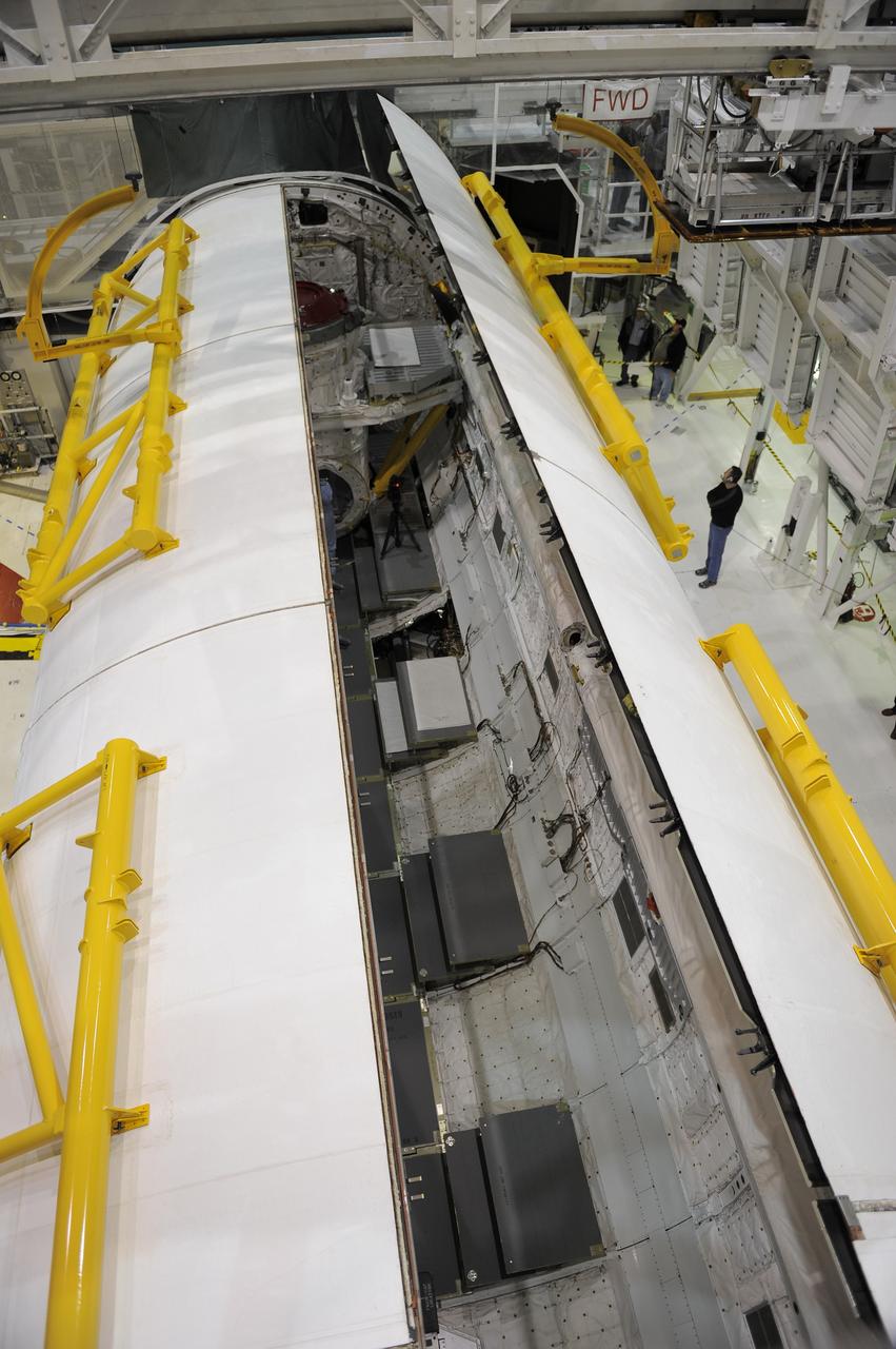 CAPE CANAVERAL, Fla. -- In Orbiter Processing Facility-1 at NASA's Kennedy Space Center in Florida, shuttle Atlantis' payload bay doors close prior to the holidays.     Atlantis is being prepared for the "launch on need," or potential rescue mission, for the final planned shuttle flight, Endeavour's STS-134 mission. For more information, visit www.nasa.gov/shuttle. Photo credit: NASA/Kim Shiflett