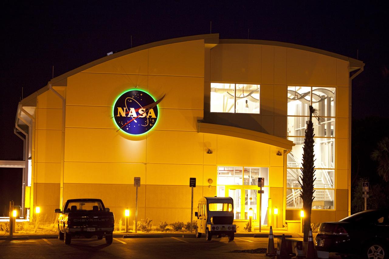 CAPE CANAVERAL, Fla. -- Kennedy Space Center's Propellants North Administrative and Maintenance Facility with the NASA insignia glistens a shade of green in the Launch Complex 39 area. The environmentally friendly facility is slated to be NASA's second Platinum-rated by the U.S. Green Building Council's (USGBC) Leadership in Environmental and Energy Design (LEED) certification system. It will be the space agency's first carbon-neutral facility, which means it will produce enough energy onsite from renewable sources to offset what it requires to operate. Shown here is the facility's two-story administrative building, which will house managers, mechanics and technicians who fuel spacecraft at Kennedy. Next door is a single-story shop that will be used to store cryogenic fuel transfer equipment.         Photo credit: NASA/Frank Michaux