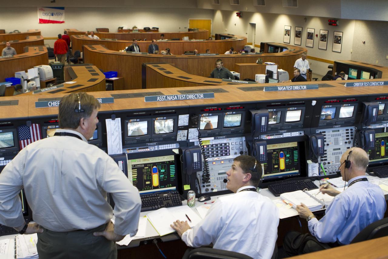 CAPE CANAVERAL, Fla. -- Team members stationed at consoles in the Launch Control Center at NASA's Kennedy Space Center in Florida monitor space shuttle Discovery's external fuel tank as it is loaded with more than 535,000 gallons of cryogenic propellants. From left, are STS-133 Assistant NASA Test Director Jeff Spaulding, NASA Test Director Jeremy Graeber and STS-133 NASA Test Director Steve Payne. During today's tanking test, the team is paying particular attention to the external tank's ribbed intertank region. Beginning tomorrow, engineers will evaluate data on 21-foot-long, U-shaped aluminum brackets, called stringers, and the newly replaced ground umbilical carrier plate (GUCP). Discovery's first launch attempt for STS-133 was scrubbed in early November due to a hydrogen gas leak at the GUCP. In order to perform additional analysis on the tank, Discovery will be rolled back to the Vehicle Assembly Building, a move that is planned for next week. The next launch opportunity is no earlier than Feb. 3, 2011. For more information on STS-133, visit www.nasa.gov/mission_pages/shuttle/shuttlemissions/sts133/. Photo credit: NASA/Cory Huston