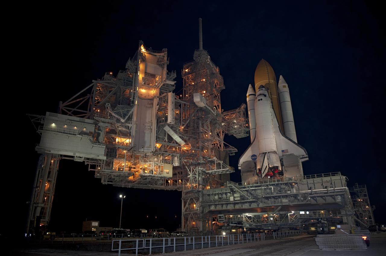 CAPE CANAVERAL, Fla. -- Space shuttle Discovery awaits its move, called rollback, from Launch Pad 39A to the Vehicle Assembly Building (VAB) at NASA's Kennedy Space Center in Florida. Rollback was scheduled for 12:30 a.m., but was postponed until 10 p.m. so technicians could resolve an issue with a leveling system on the crawler-transporter. Once inside the VAB, Discovery's external fuel tank will be examined and foam reapplied where 89 sensors were installed on the tank's aluminum skin for an instrumented tanking test on Dec. 17. The sensors were used to measure changes in the tank as super-cold propellants were pumped in and drained out. Data and analysis from the test will be used to determine what caused the tops of two, 21-foot-long support beams, called stringers, on the outside of the intertank to crack during fueling on Nov. 5.                Discovery's next launch opportunity is no earlier than Feb. 3, 2011. For more information on STS-133, visit www.nasa.gov/mission_pages/shuttle/shuttlemissions/sts133/. Photo credit: NASA/Kim Shiflett