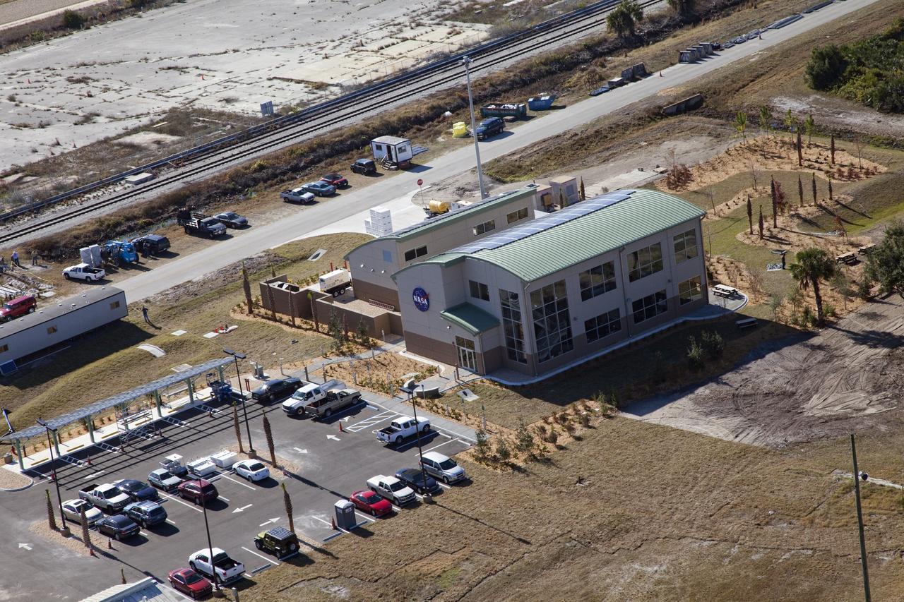 CAPE CANAVERAL, Fla. -- The Propellants North Administrative and Maintenance Facility in the Launch Complex 39 area of NASA's Kennedy Space Center in Florida is ready for business. The environmentally friendly facility is slated to be NASA's second Platinum-rated by the U.S. Green Building Council's (USGBC) Leadership in Environmental and Energy Design (LEED) certification system. It will be the space agency's first carbon-neutral facility, which means it will produce enough energy onsite from renewable sources to offset what it requires to operate. On the right is the facility's two-story administrative building, which will house managers, mechanics and technicians who fuel spacecraft at Kennedy. On the left is a single-story shop that will be used to store cryogenic fuel transfer equipment. In the parking lot is a solar-powered parking station for alternative fuel vehicles. Photo credit: NASA/Frank Michaux
