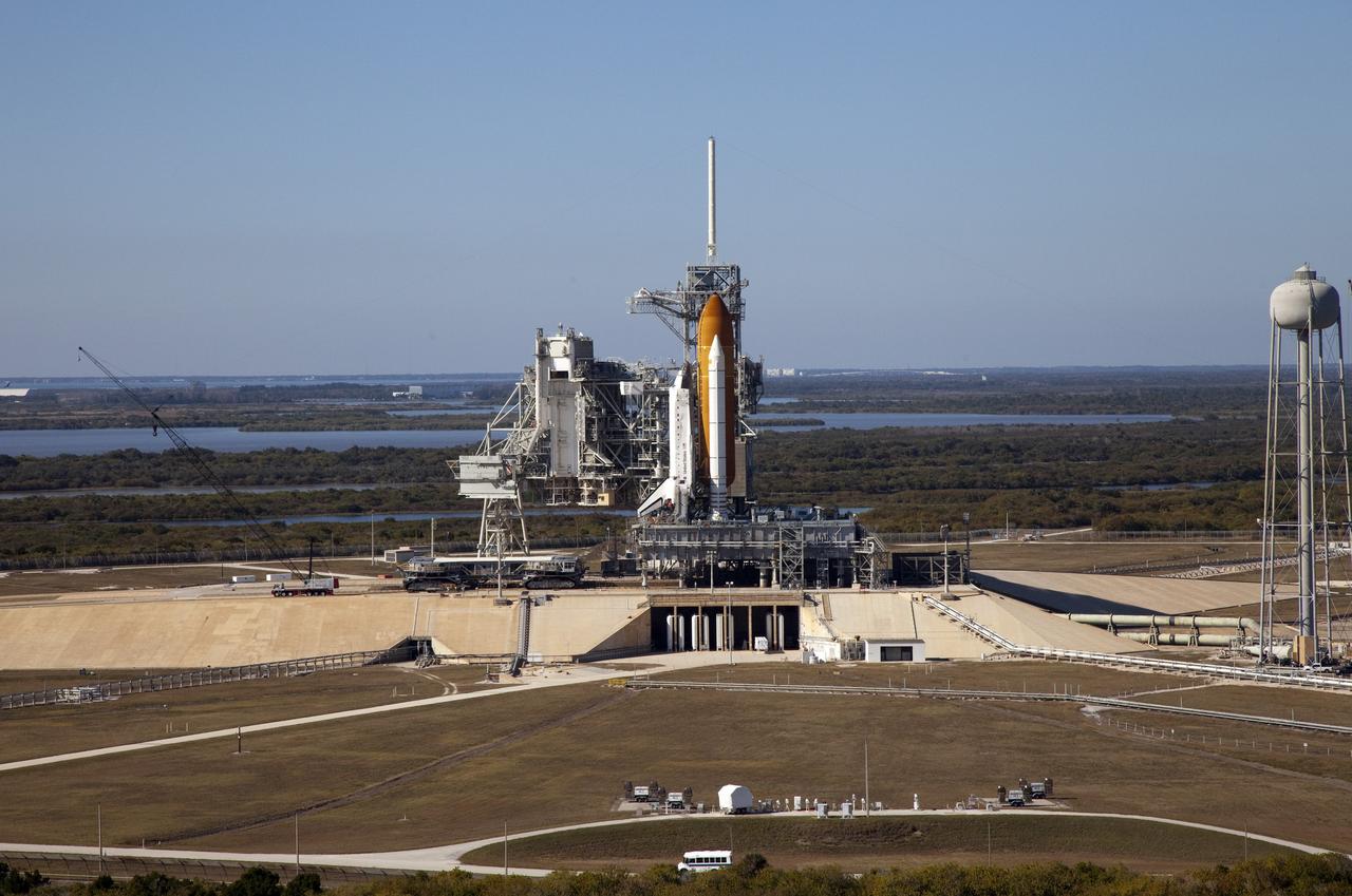 CAPE CANAVERAL, Fla. -- Space shuttle Discovery awaits its move, called rollback, from Launch Pad 39A to the Vehicle Assembly Building (VAB) at NASA's Kennedy Space Center in Florida. Rollback was scheduled for 12:30 a.m., but was postponed until 10 p.m. so technicians could resolve an issue with a leveling system on the crawler-transporter, which is to the left of the shuttle. Once inside the VAB, Discovery's external fuel tank will be examined and foam reapplied where 89 sensors were installed on the tank's aluminum skin for an instrumented tanking test on Dec. 17. The sensors were used to measure changes in the tank as super-cold propellants were pumped in and drained out. Data and analysis from the test will be used to determine what caused the tops of two, 21-foot-long support beams, called stringers, on the outside of the intertank to crack during fueling on Nov. 5.            Discovery's next launch opportunity to the International Space Station on the STS-133 mission is no earlier than Feb. 3, 2011. For more information on STS-133, visit www.nasa.gov/mission_pages/shuttle/shuttlemissions/sts133/. Photo credit: NASA/Frank Michaux