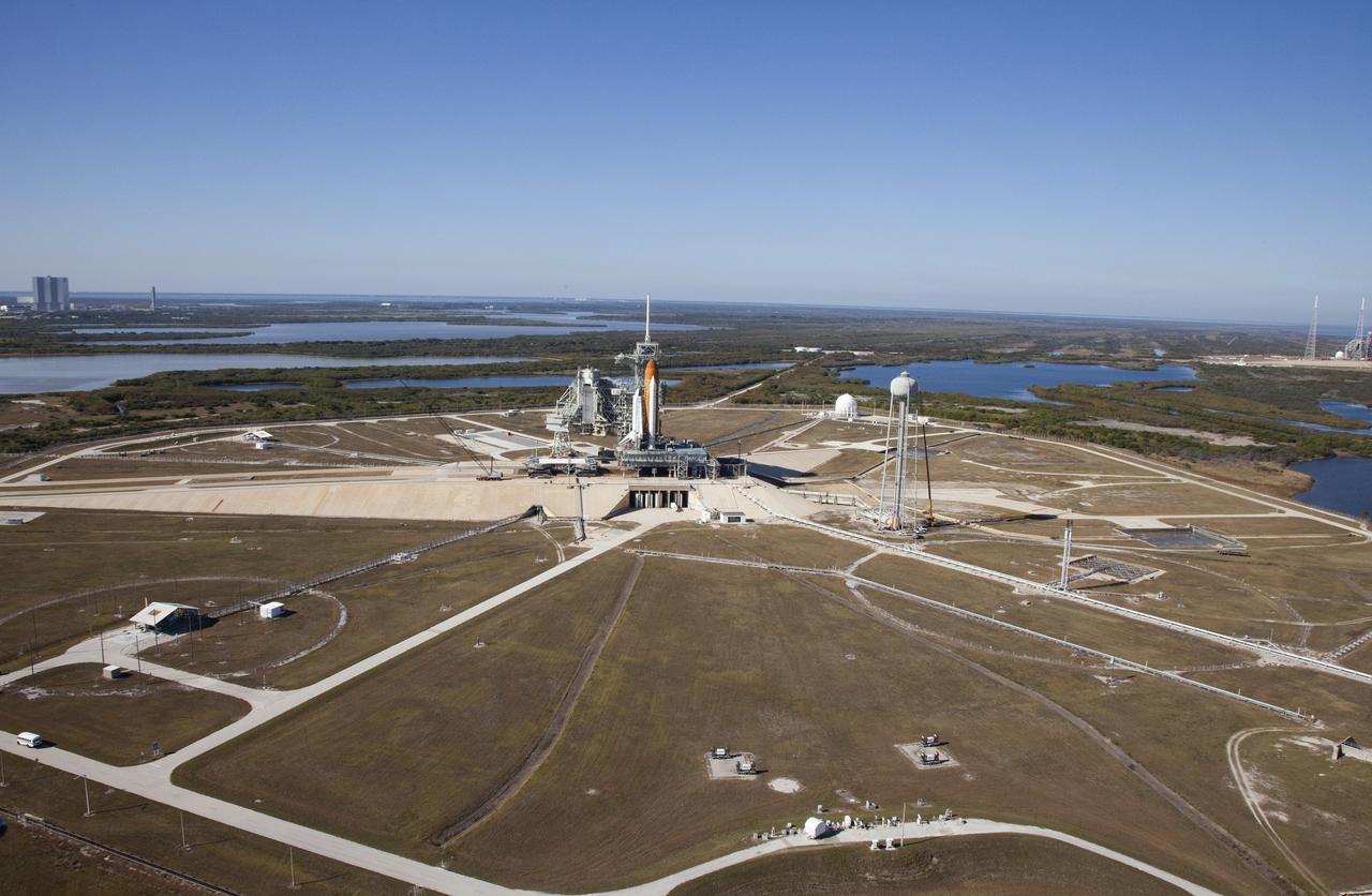 CAPE CANAVERAL, Fla. -- Space shuttle Discovery awaits its move, called rollback, from Launch Pad 39A to the Vehicle Assembly Building (VAB) at NASA's Kennedy Space Center in Florida. Rollback was scheduled for 12:30 a.m., but was postponed until 10 p.m. so technicians could resolve an issue with a leveling system on the crawler-transporter. Once inside the VAB, Discovery's external fuel tank will be examined and foam reapplied where 89 sensors were installed on the tank's aluminum skin for an instrumented tanking test on Dec. 17. The sensors were used to measure changes in the tank as super-cold propellants were pumped in and drained out. Data and analysis from the test will be used to determine what caused the tops of two, 21-foot-long support beams, called stringers, on the outside of the intertank to crack during fueling on Nov. 5.          Discovery's next launch opportunity to the International Space Station on the STS-133 mission is no earlier than Feb. 3, 2011. For more information on STS-133, visit www.nasa.gov/mission_pages/shuttle/shuttlemissions/sts133/. Photo credit: NASA/Frank Michaux
