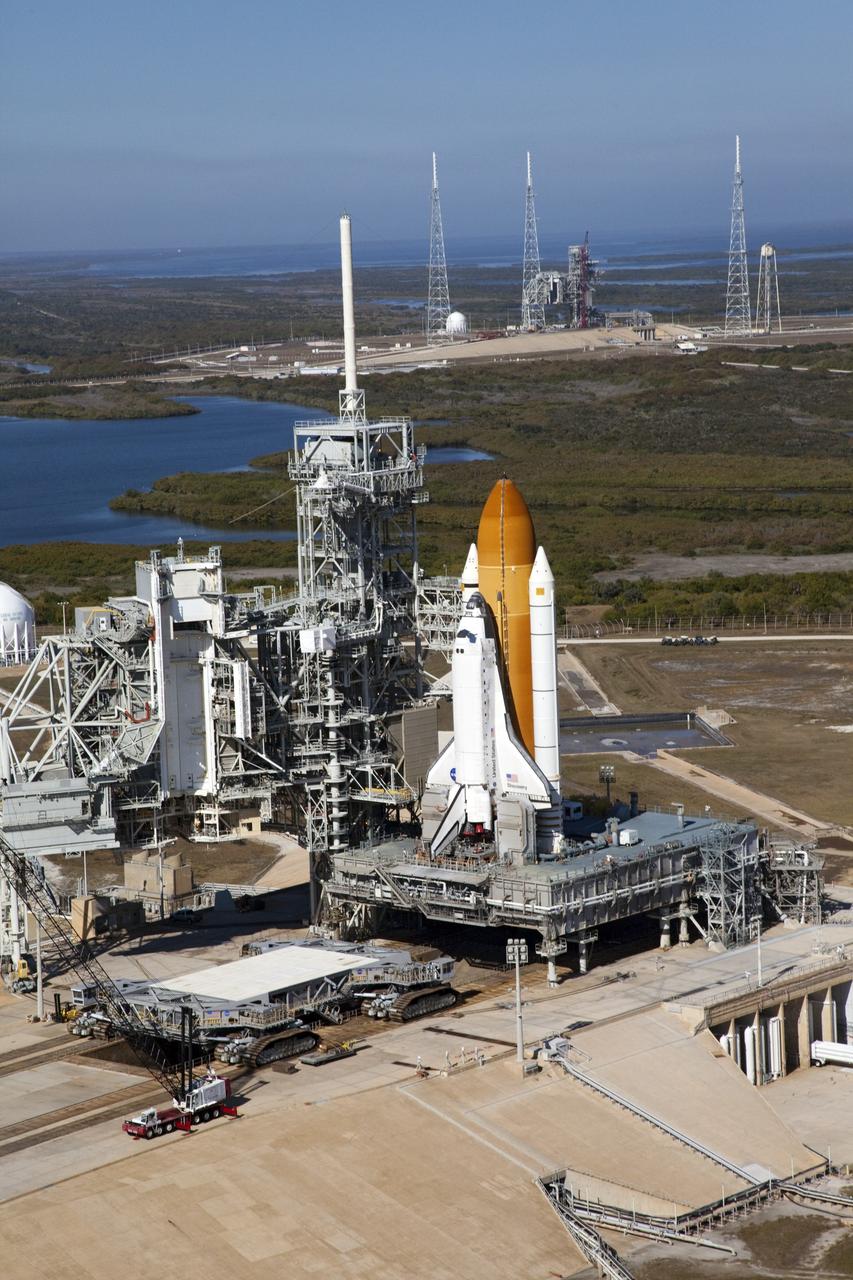 CAPE CANAVERAL, Fla. -- Space shuttle Discovery awaits its move, called rollback, from Launch Pad 39A to the Vehicle Assembly Building (VAB) at NASA's Kennedy Space Center in Florida. Rollback was scheduled for 12:30 a.m., but was postponed until 10 p.m. so technicians could resolve an issue with a leveling system on the crawler-transporter, which is to the left of the shuttle. Once inside the VAB, Discovery's external fuel tank will be examined and foam reapplied where 89 sensors were installed on the tank's aluminum skin for an instrumented tanking test on Dec. 17. The sensors were used to measure changes in the tank as super-cold propellants were pumped in and drained out. Data and analysis from the test will be used to determine what caused the tops of two, 21-foot-long support beams, called stringers, on the outside of the intertank to crack during fueling on Nov. 5.      Discovery's next launch opportunity to the International Space Station on the STS-133 mission is no earlier than Feb. 3, 2011. For more information on STS-133, visit www.nasa.gov/mission_pages/shuttle/shuttlemissions/sts133/. Photo credit: NASA/Frank Michaux