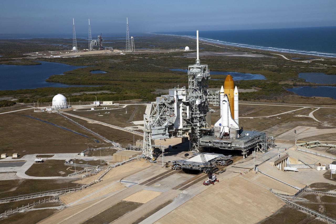 CAPE CANAVERAL, Fla. -- Space shuttle Discovery awaits its move, called rollback, from Launch Pad 39A to the Vehicle Assembly Building (VAB) at NASA's Kennedy Space Center in Florida. Rollback was scheduled for 12:30 a.m., but was postponed until 10 p.m. so technicians could resolve an issue with a leveling system on the crawler-transporter, which is in front of the shuttle. Once inside the VAB, Discovery's external fuel tank will be examined and foam reapplied where 89 sensors were installed on the tank's aluminum skin for an instrumented tanking test on Dec. 17. The sensors were used to measure changes in the tank as super-cold propellants were pumped in and drained out. Data and analysis from the test will be used to determine what caused the tops of two, 21-foot-long support beams, called stringers, on the outside of the intertank to crack during fueling on Nov. 5.    Discovery's next launch opportunity to the International Space Station on the STS-133 mission is no earlier than Feb. 3, 2011. For more information on STS-133, visit www.nasa.gov/mission_pages/shuttle/shuttlemissions/sts133/. Photo credit: NASA/Frank Michaux
