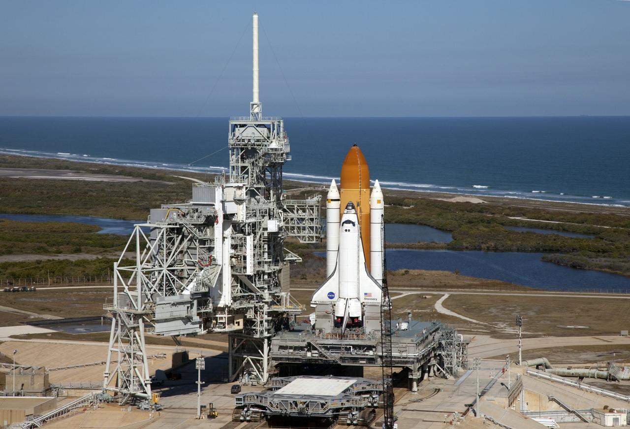 CAPE CANAVERAL, Fla. -- Space shuttle Discovery awaits its move, called rollback, from Launch Pad 39A to the Vehicle Assembly Building (VAB) at NASA's Kennedy Space Center in Florida. Rollback was scheduled for 12:30 a.m., but was postponed until 10 p.m. so technicians could resolve an issue with a leveling system on the crawler-transporter, which is in front of the shuttle. Once inside the VAB, Discovery's external fuel tank will be examined and foam reapplied where 89 sensors were installed on the tank's aluminum skin for an instrumented tanking test on Dec. 17. The sensors were used to measure changes in the tank as super-cold propellants were pumped in and drained out. Data and analysis from the test will be used to determine what caused the tops of two, 21-foot-long support beams, called stringers, on the outside of the intertank to crack during fueling on Nov. 5.          Discovery's next launch opportunity to the International Space Station on the STS-133 mission is no earlier than Feb. 3, 2011. For more information on STS-133, visit www.nasa.gov/mission_pages/shuttle/shuttlemissions/sts133/. Photo credit: NASA/Frank Michaux