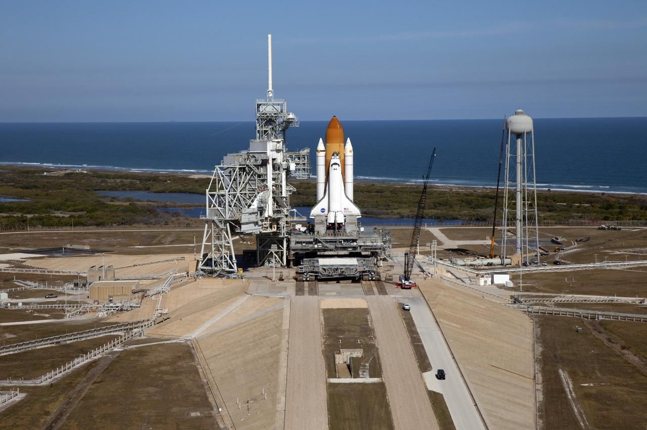 CAPE CANAVERAL, Fla. -- Space shuttle Discovery awaits its move, called rollback, from Launch Pad 39A to the Vehicle Assembly Building (VAB) at NASA's Kennedy Space Center in Florida. Rollback was scheduled for 12:30 a.m., but was postponed until 10 p.m. so technicians could resolve an issue with a leveling system on the crawler-transporter, which is in front of the shuttle. Once inside the VAB, Discovery's external fuel tank will be examined and foam reapplied where 89 sensors were installed on the tank's aluminum skin for an instrumented tanking test on Dec. 17. The sensors were used to measure changes in the tank as super-cold propellants were pumped in and drained out. Data and analysis from the test will be used to determine what caused the tops of two, 21-foot-long support beams, called stringers, on the outside of the intertank to crack during fueling on Nov. 5.        Discovery's next launch opportunity to the International Space Station on the STS-133 mission is no earlier than Feb. 3, 2011. For more information on STS-133, visit www.nasa.gov/mission_pages/shuttle/shuttlemissions/sts133/. Photo credit: NASA/Frank Michaux
