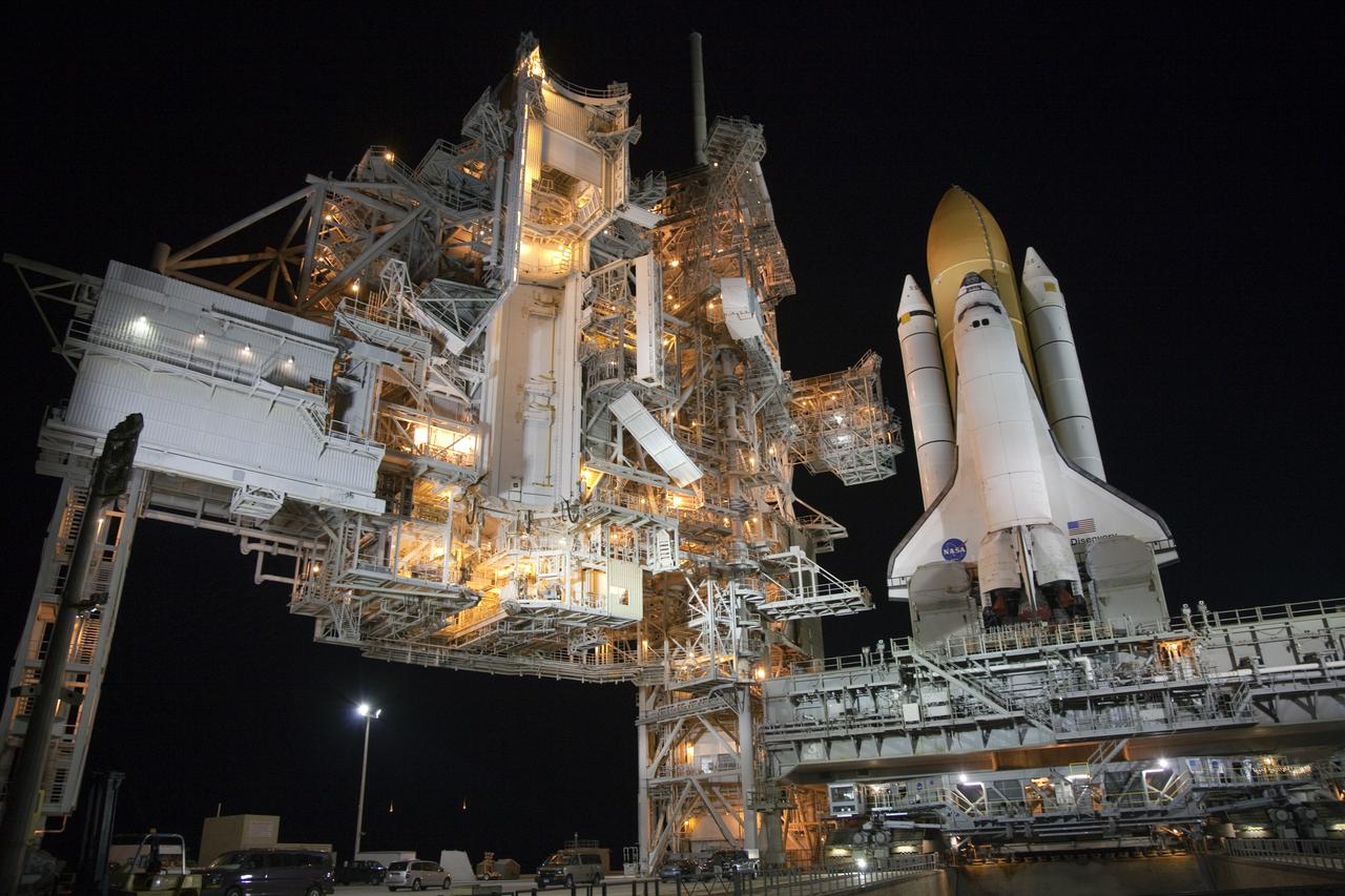 CAPE CANAVERAL, Fla. -- Space shuttle Discovery, secured to a crawler-transporter, slowly moves away from Launch Pad 39A at NASA's Kennedy Space Center in Florida. The 3.4-mile trek, called rollback, to the Vehicle Assembly Building began at 10:48 p.m. and took about eight hours. Next, Discovery's external fuel tank will be examined and foam reapplied where 89 sensors were installed on the tank's aluminum skin for an instrumented tanking test on Dec. 17. The sensors were used to measure changes in the tank as super-cold propellants were pumped in and drained out. Data and analysis from the test will be used to determine what caused the tops of two, 21-foot-long support beams, called stringers, on the outside of the intertank to crack during fueling on Nov. 5.      Discovery's next launch opportunity to the International Space Station on the STS-133 mission is no earlier than Feb. 3, 2011. For more information on STS-133, visit www.nasa.gov/mission_pages/shuttle/shuttlemissions/sts133/. Photo credit: NASA/Frank Michaux